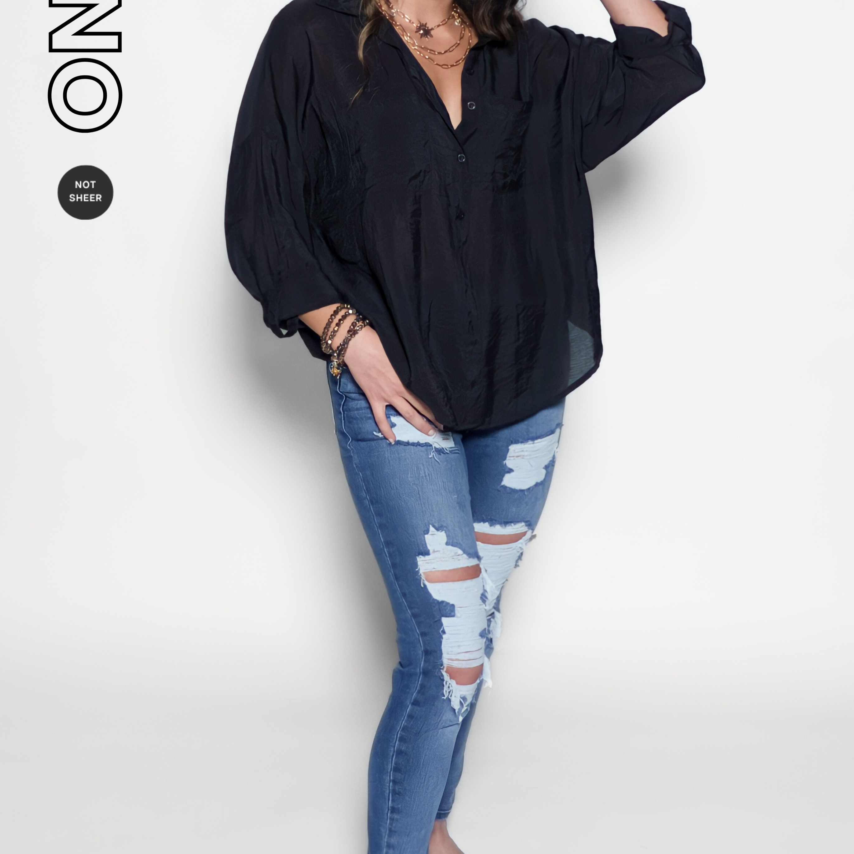 Woman wearing a black shirt and blue jeans on a white background