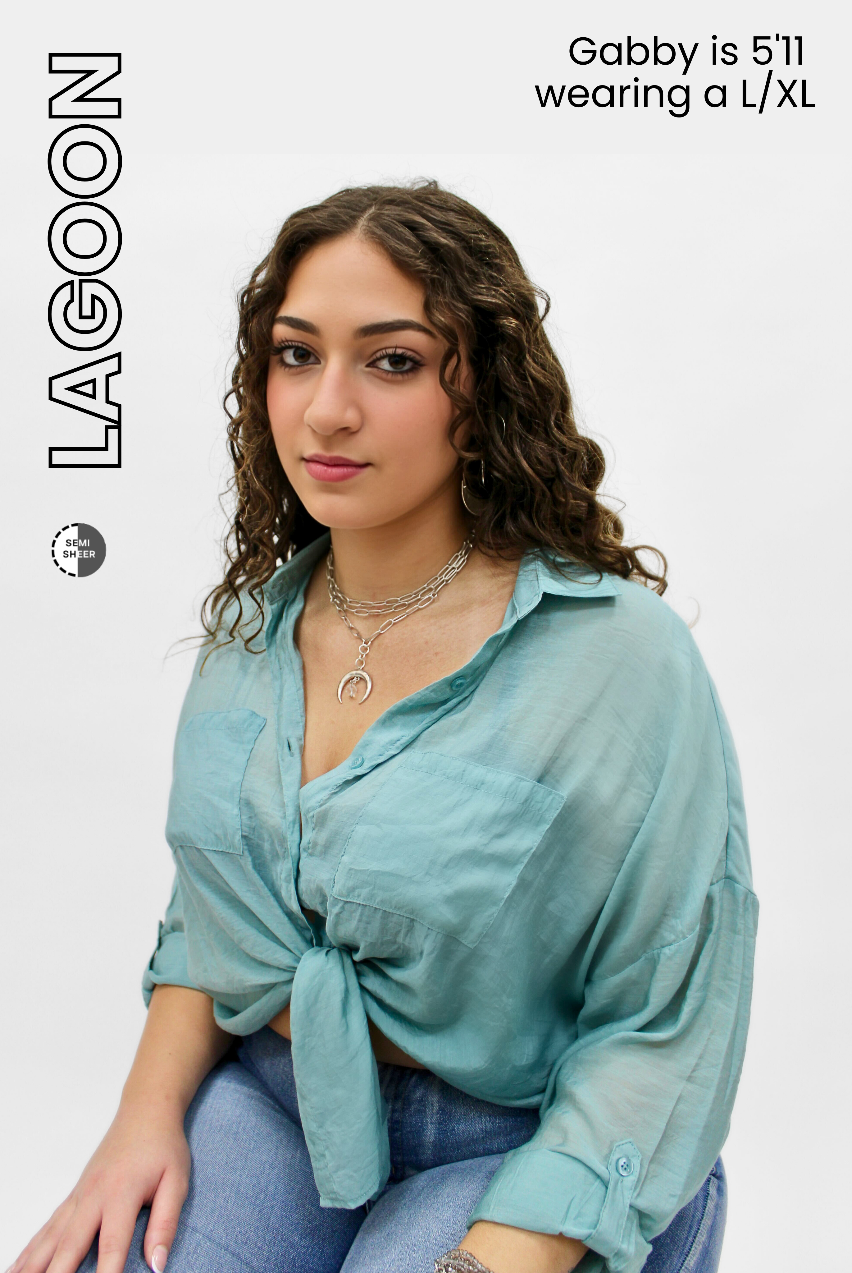 Woman wearing a light blue shirt sitting on a white background with 'Lagoon' branding.