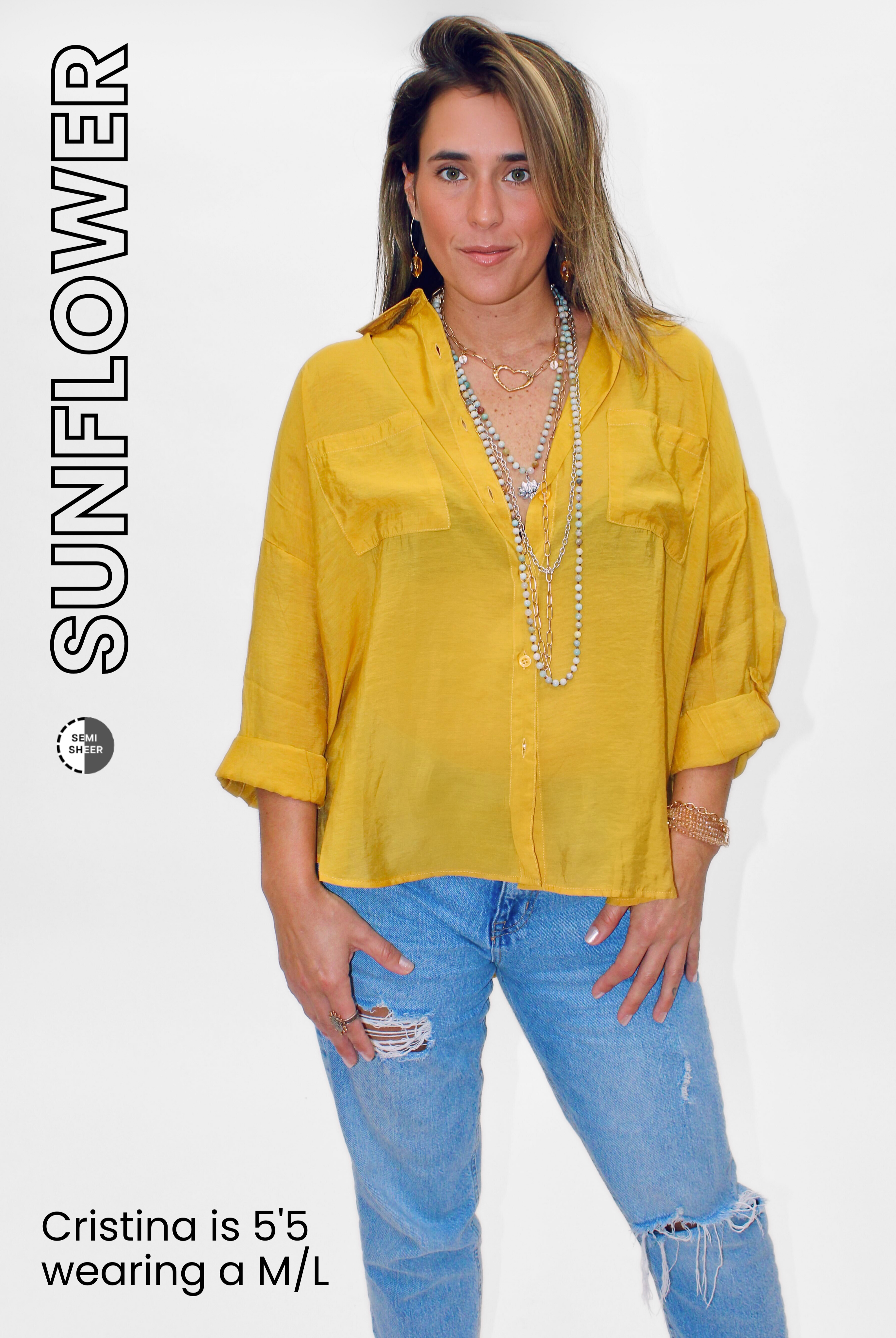 Woman wearing a yellow shirt and blue jeans with 'Sunflower' branding.
