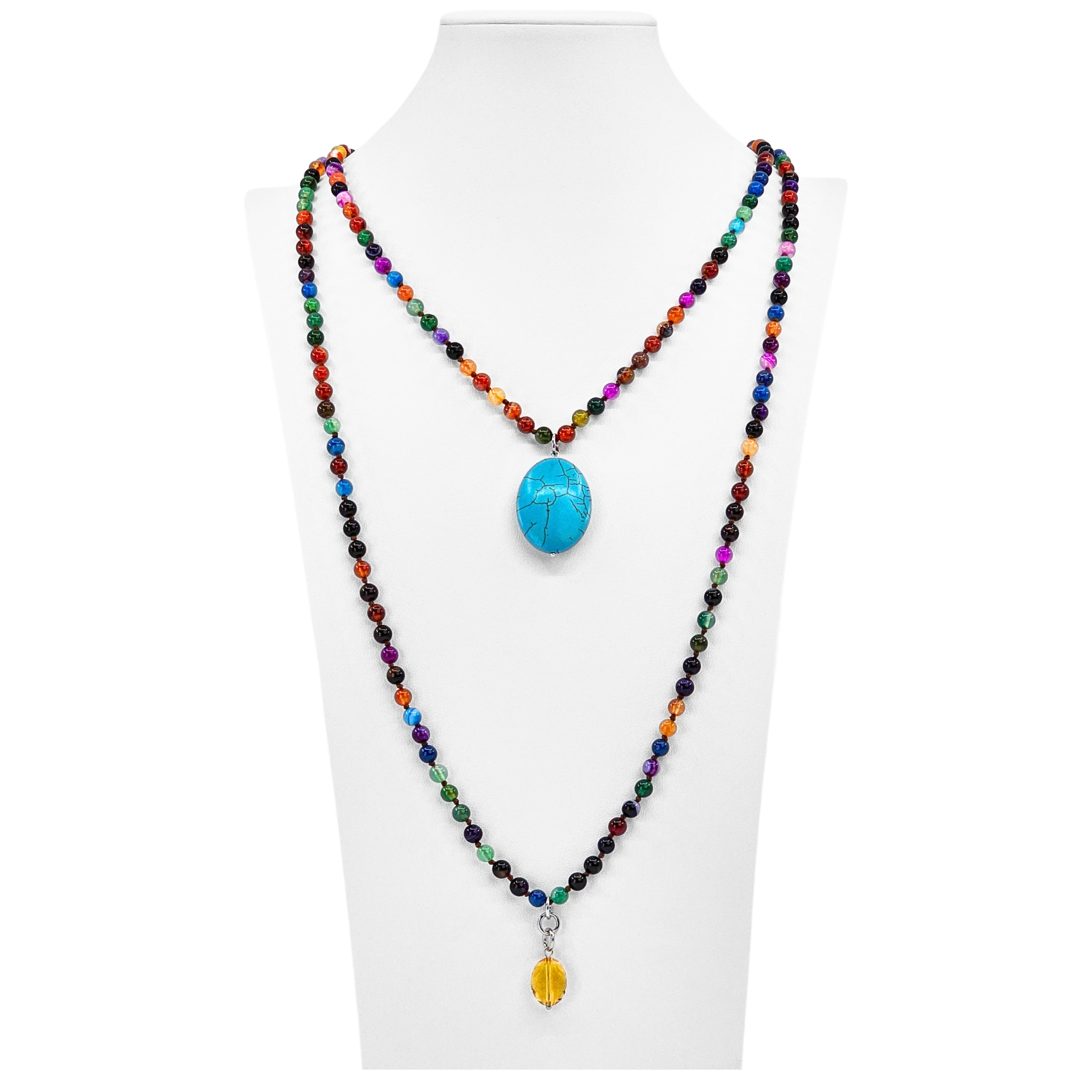 Colorful beaded necklace with a blue pendant on a white mannequin.