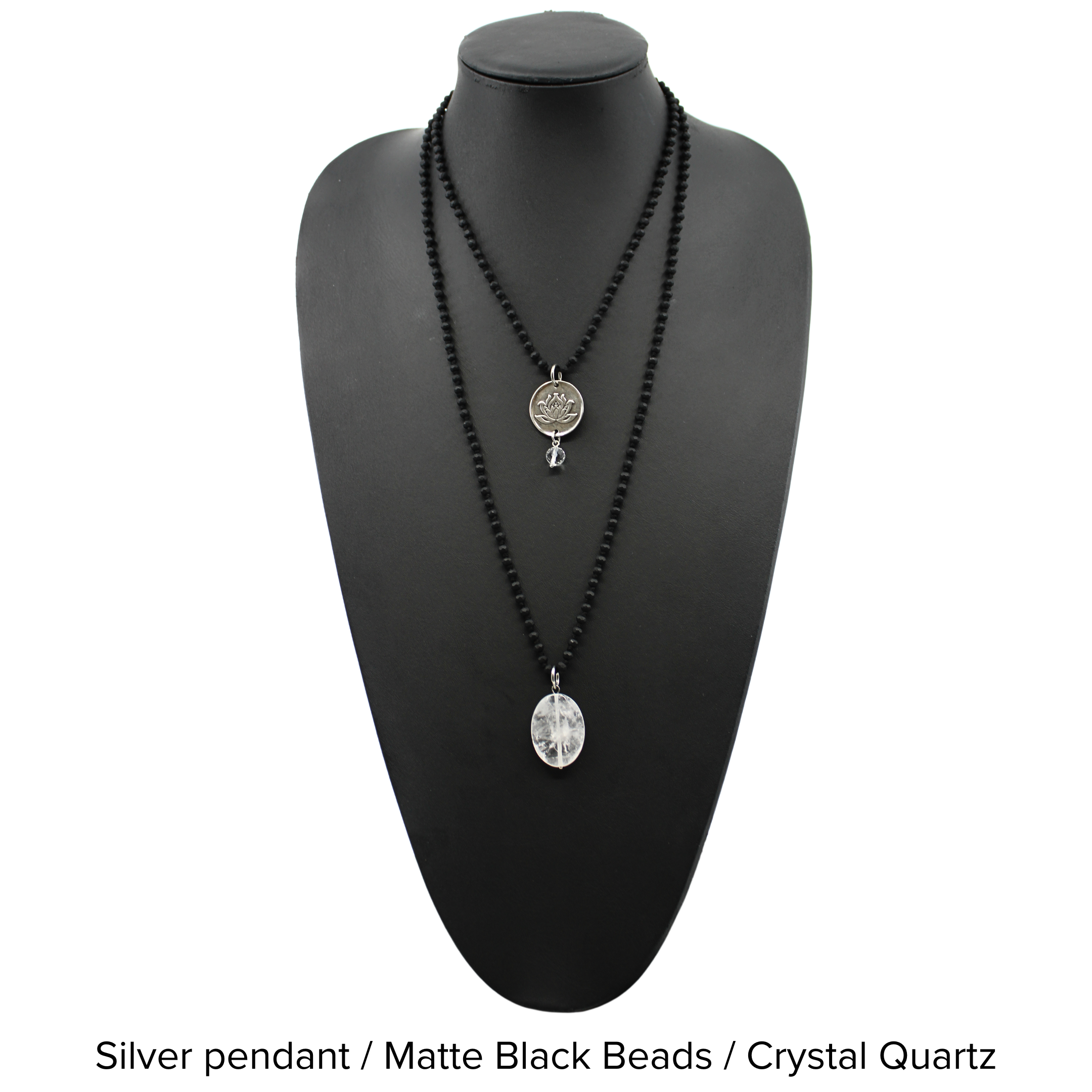 Two versions of the 'Just Breathe Lotus Original Necklace,' one with a gold finish and a lotus flower design, and another with a silver finish with the text 'JUST BREATHE' on it, both with beaded chains and a crystal accent.