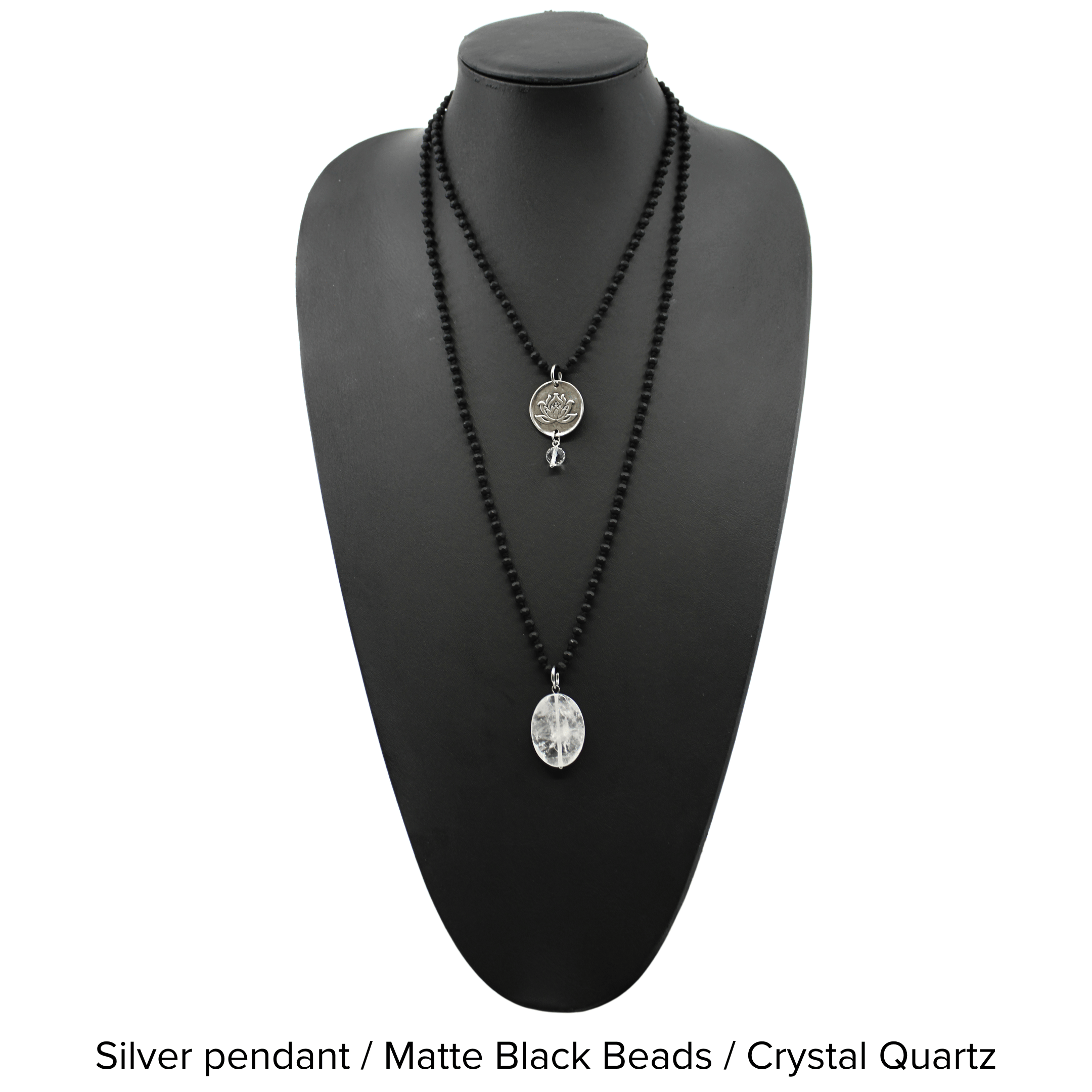 Two versions of the 'Just Breathe Lotus Original Necklace,' one with a gold finish and a lotus flower design, and another with a silver finish with the text 'JUST BREATHE' on it, both with beaded chains and a crystal accent.