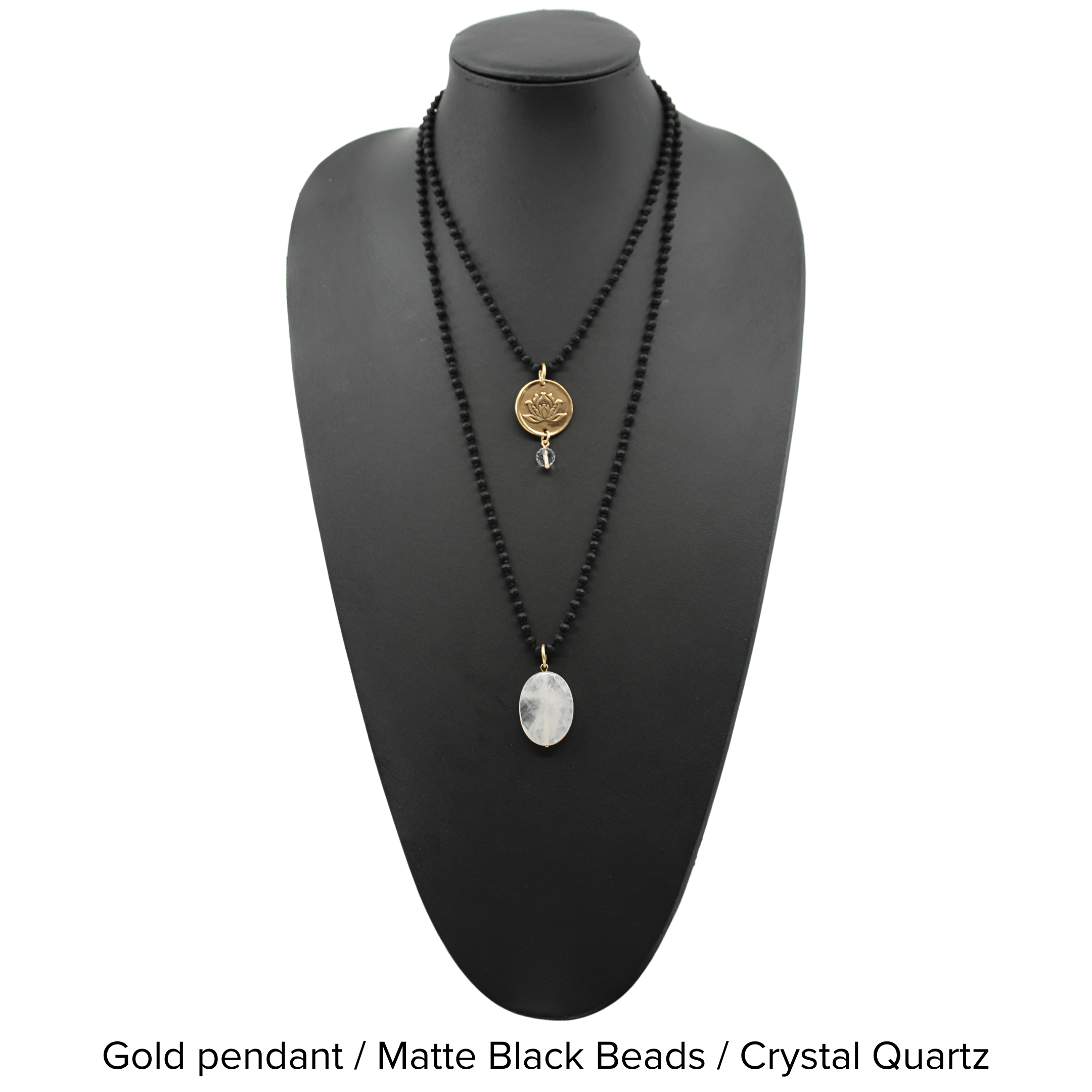 Two versions of the 'Just Breathe Lotus Original Necklace,' one with a gold finish and a lotus flower design, and another with a silver finish with the text 'JUST BREATHE' on it, both with beaded chains and a crystal accent.