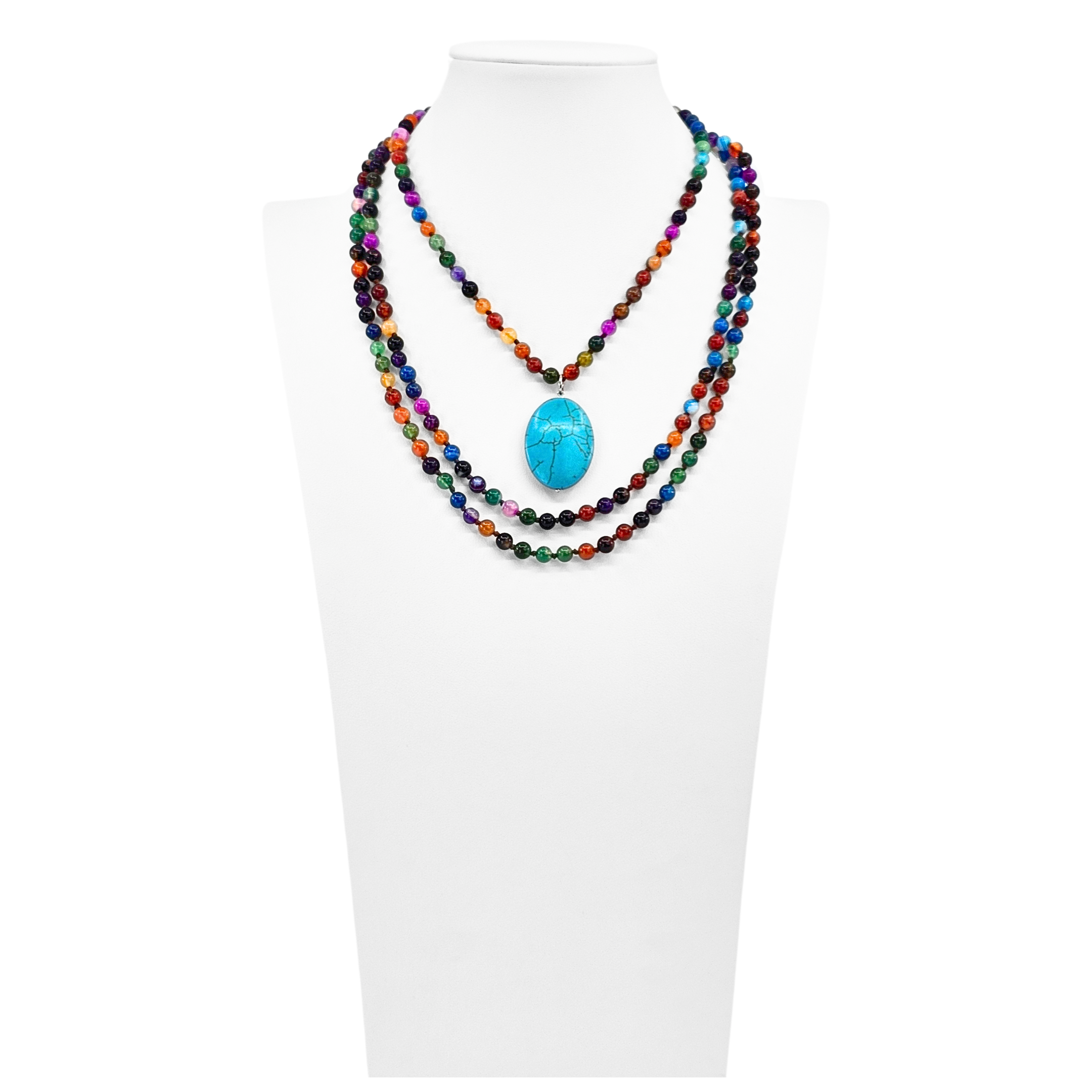 Colorful beaded necklace with a turquoise pendant on a white mannequin.