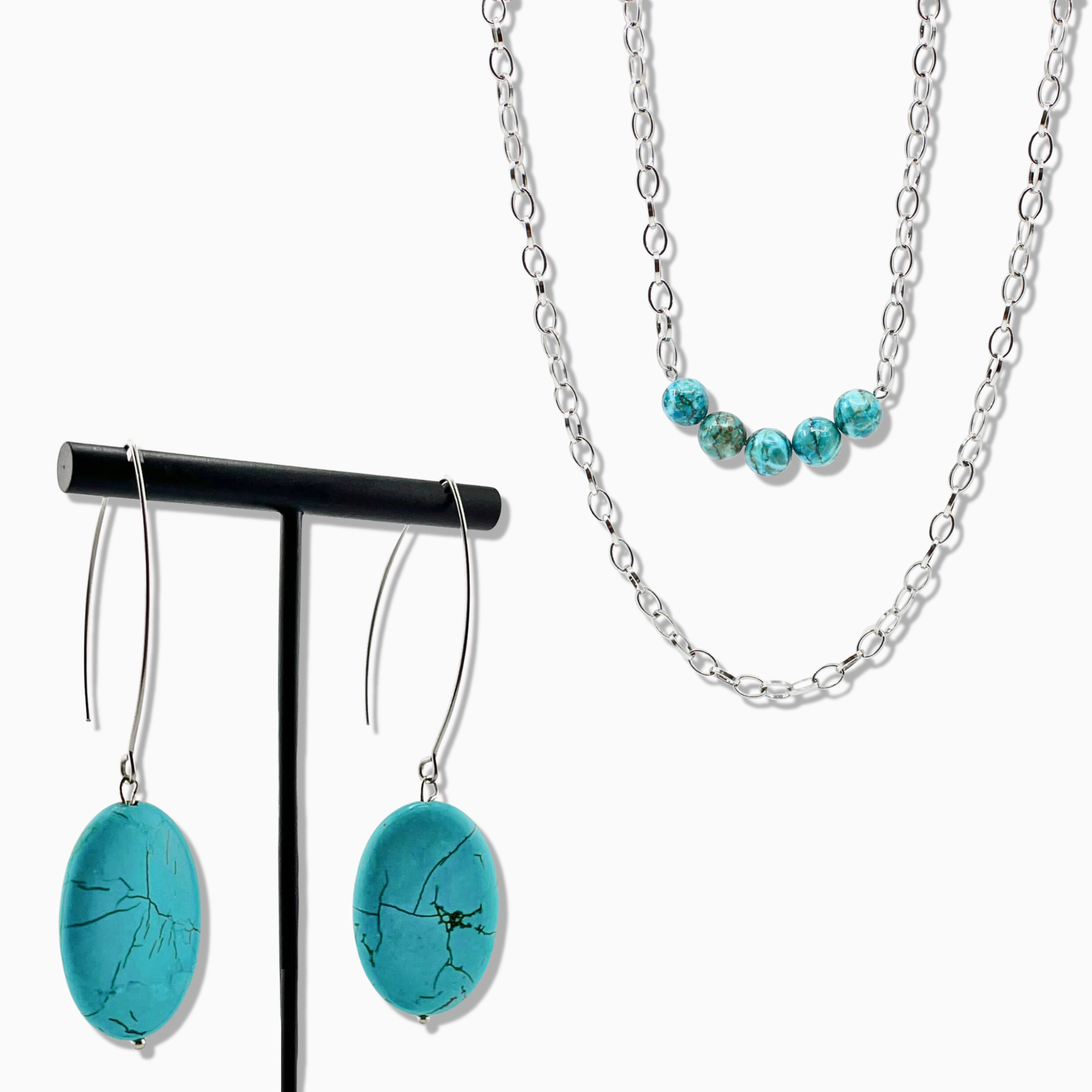 Turquoise pendant necklace with a silver chain on a white background