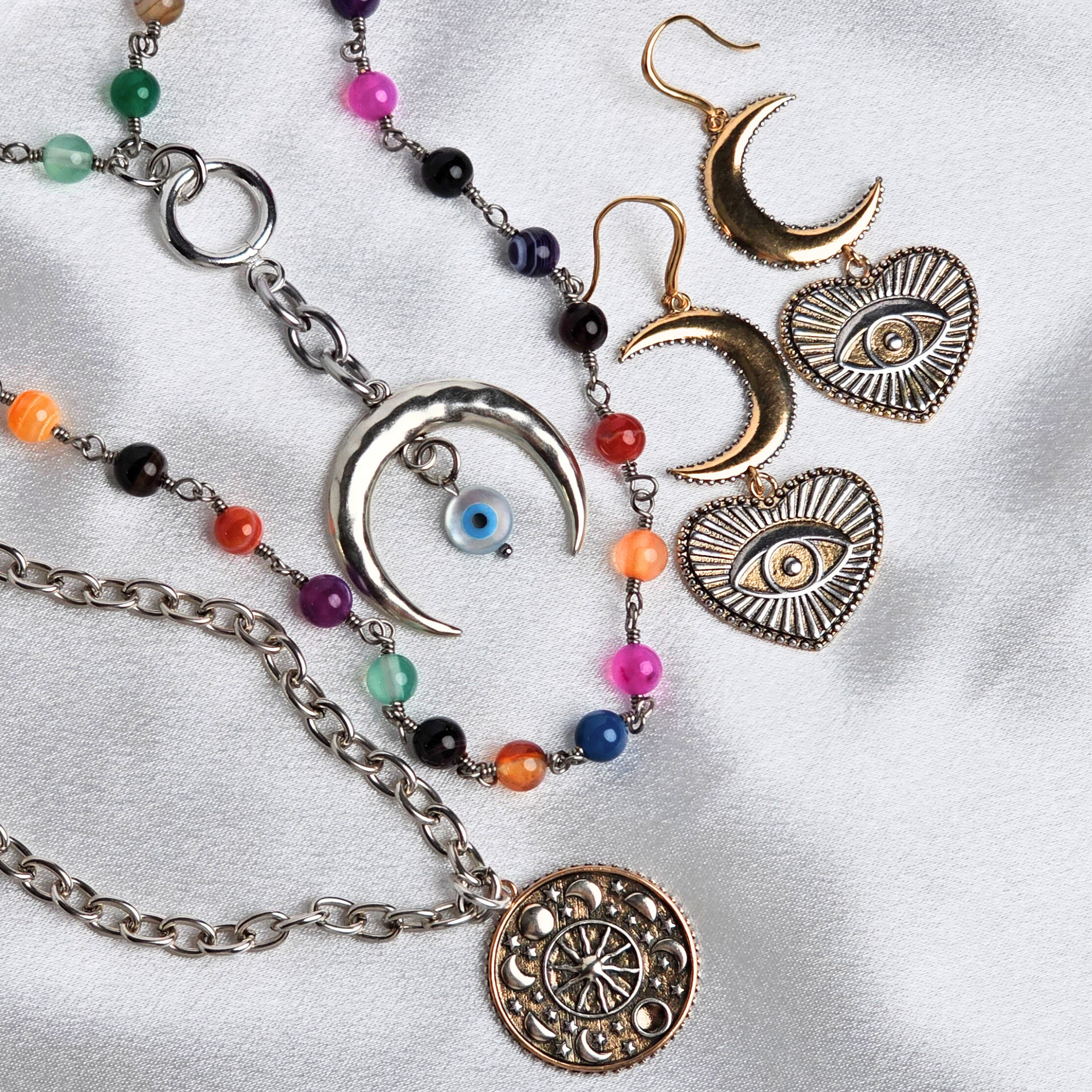 Jewelry set with necklaces and earrings on a white background