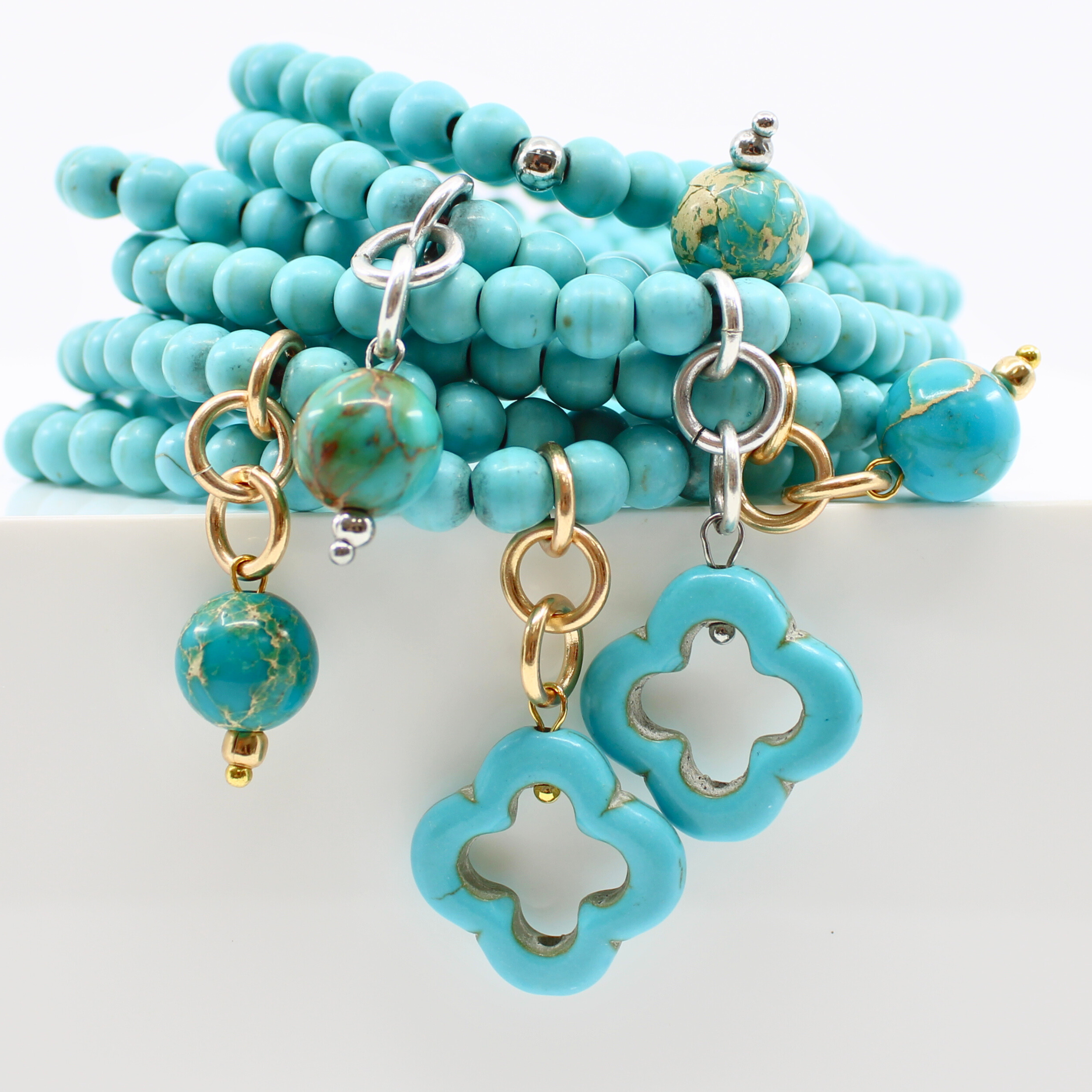 multiple colorful beaded boho wrap bracelets in 4 bright colors made with howlite beads. this image shows the turquoise blue one in both finish options