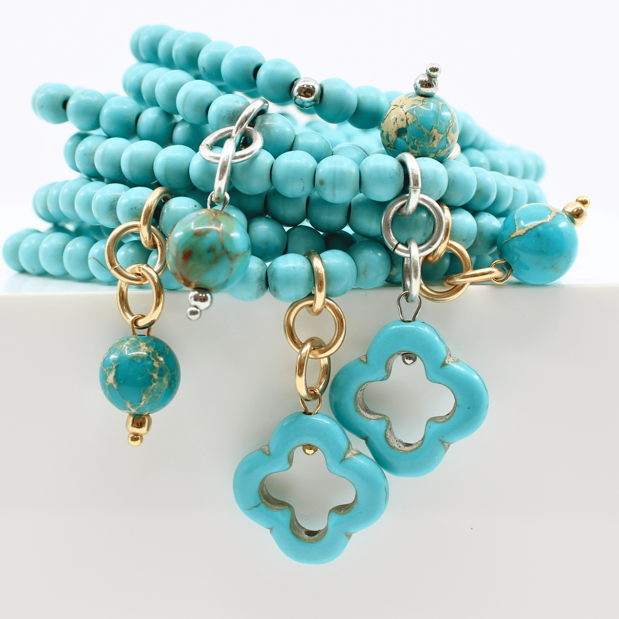 multiple colorful beaded boho wrap bracelets in 4 bright colors made with howlite beads. this image shows the turquoise blue one in both finish options