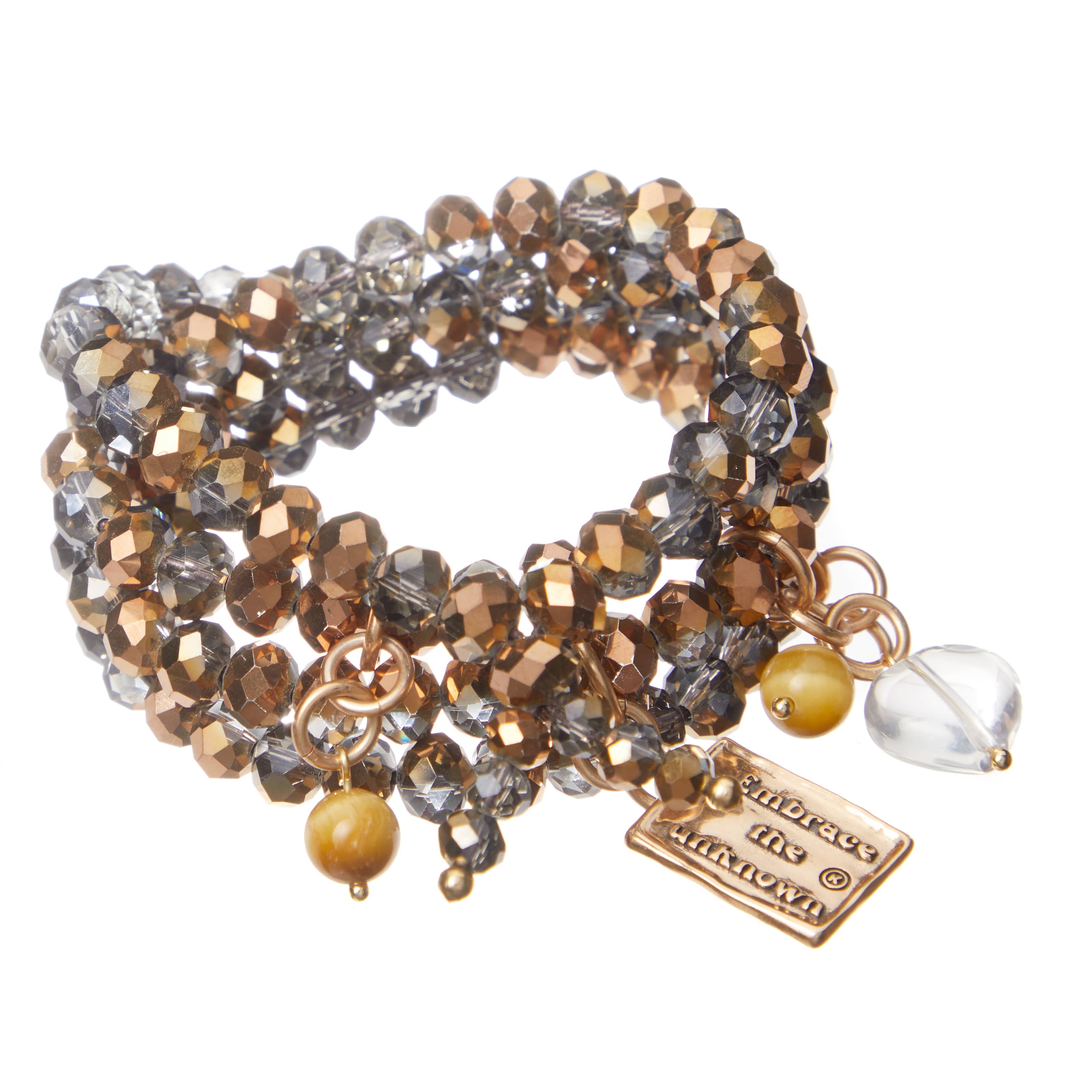 A person's wrist wearing a boho wrap bracelet with gold finish pendant, tiger eye, and crystal quartz heart.