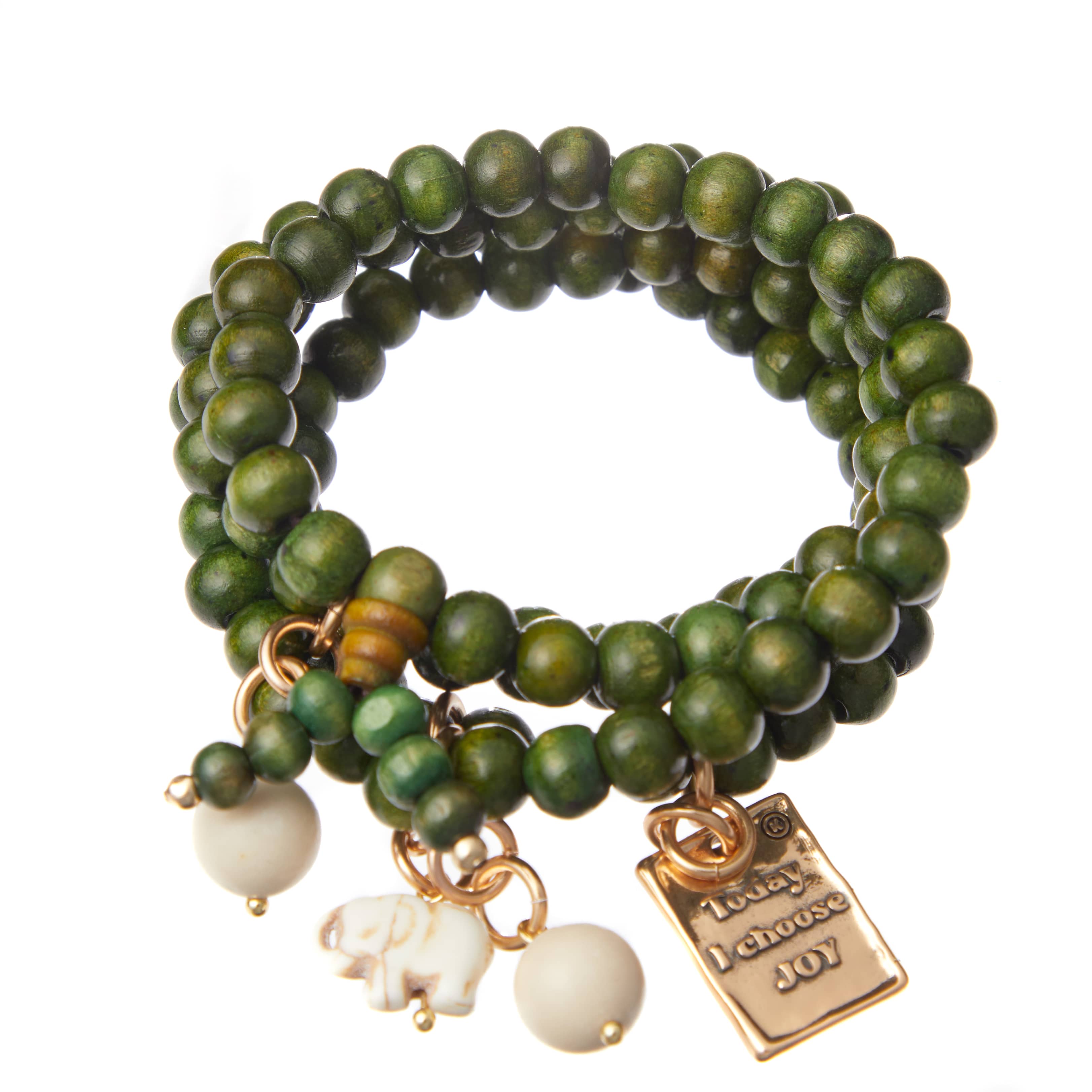 A green wooden boho wrap bracelet with gold finish pendant and off-white howlite elephant charm, displayed on a white background.