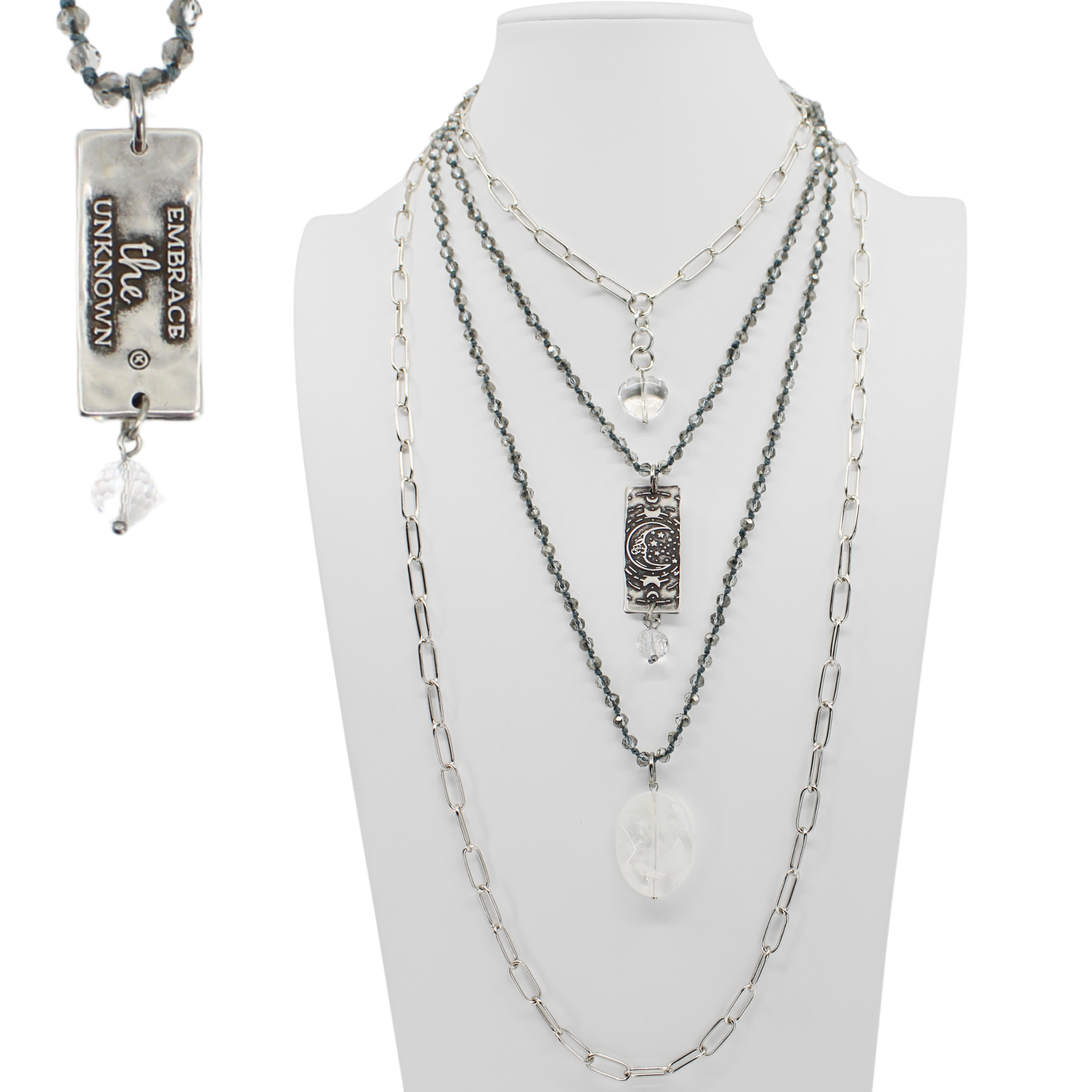 Multiple necklaces on a mannequin bust with visible brand name.