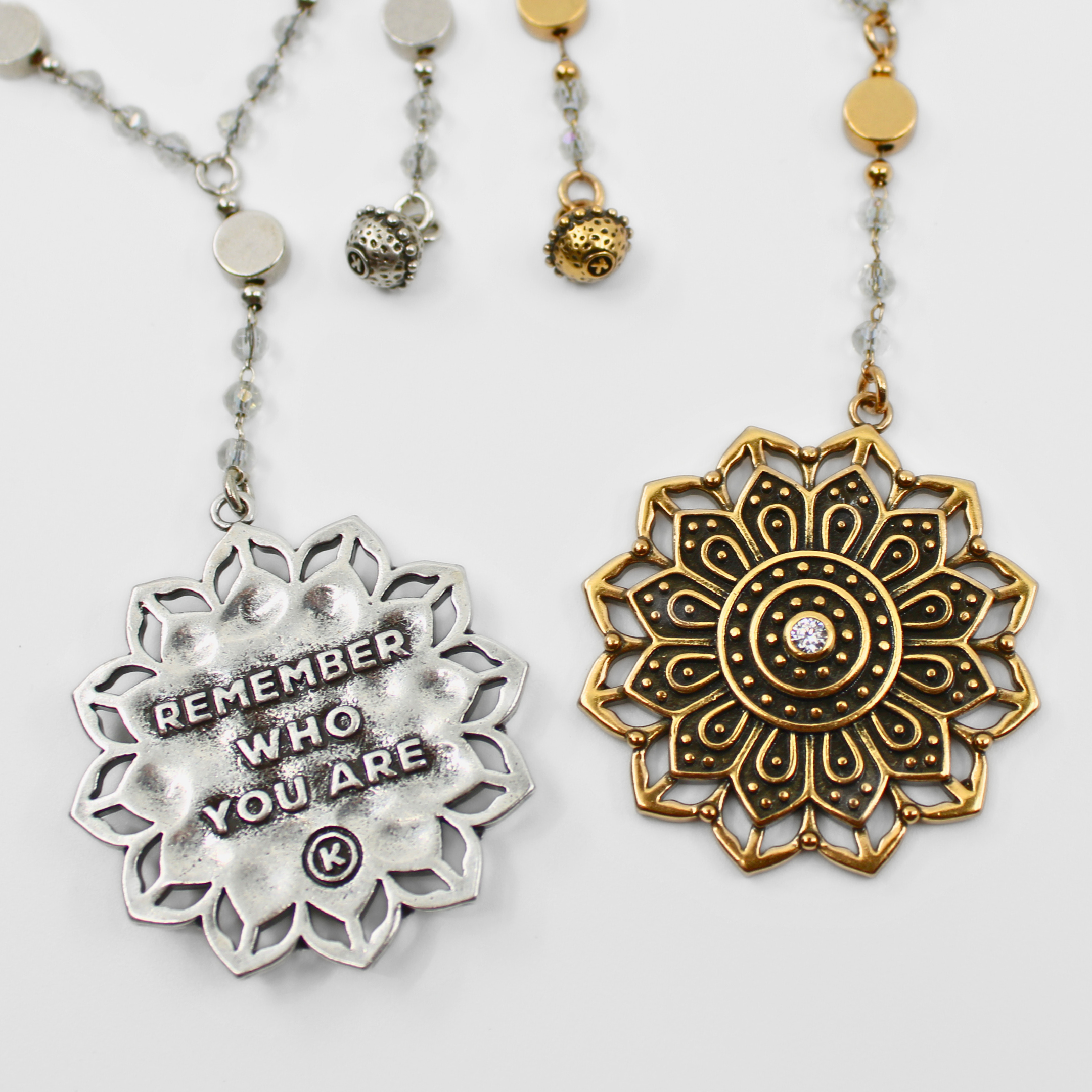 Two decorative necklaces with mandala designs on a white background