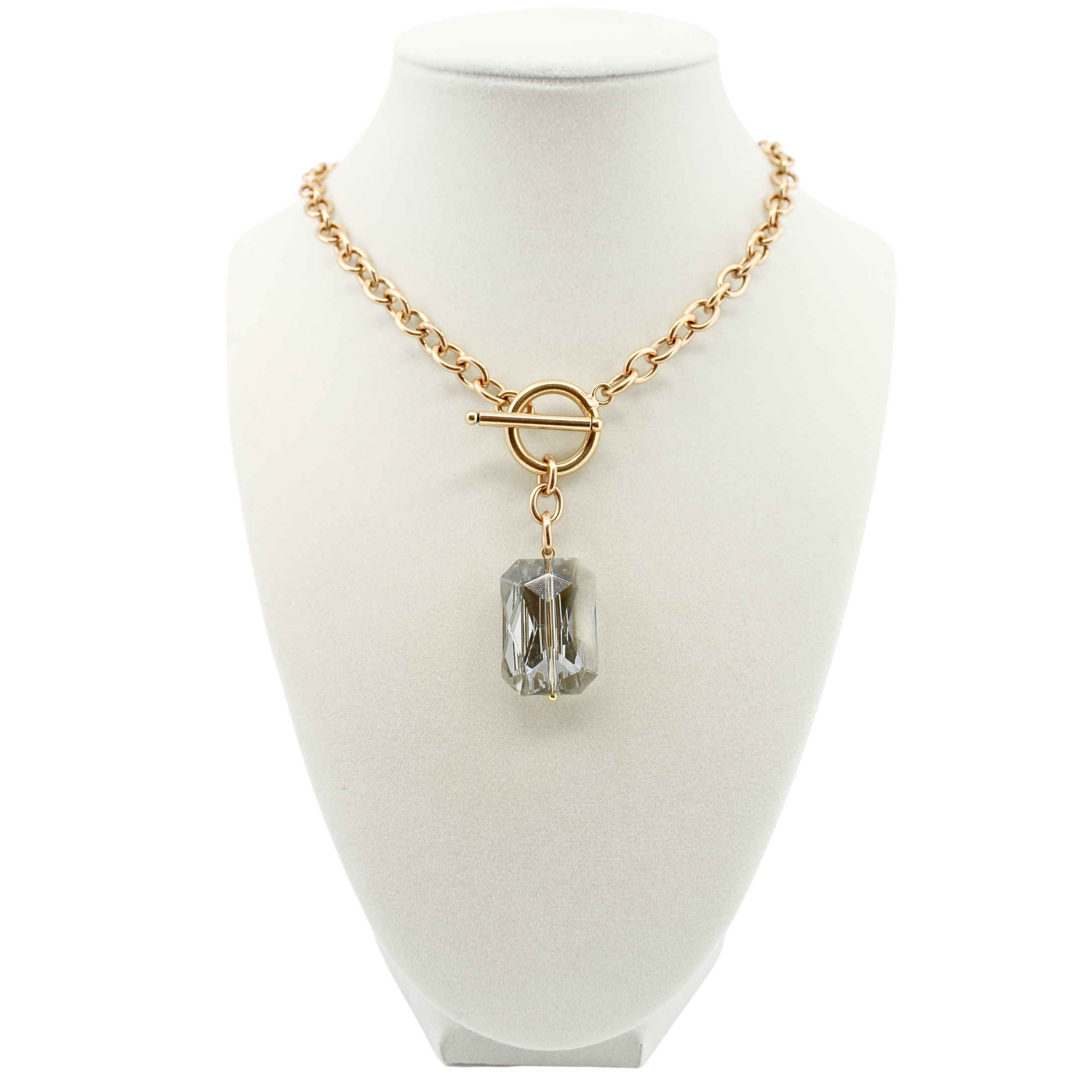 Gold necklace with a clear pendant on a white mannequin bust