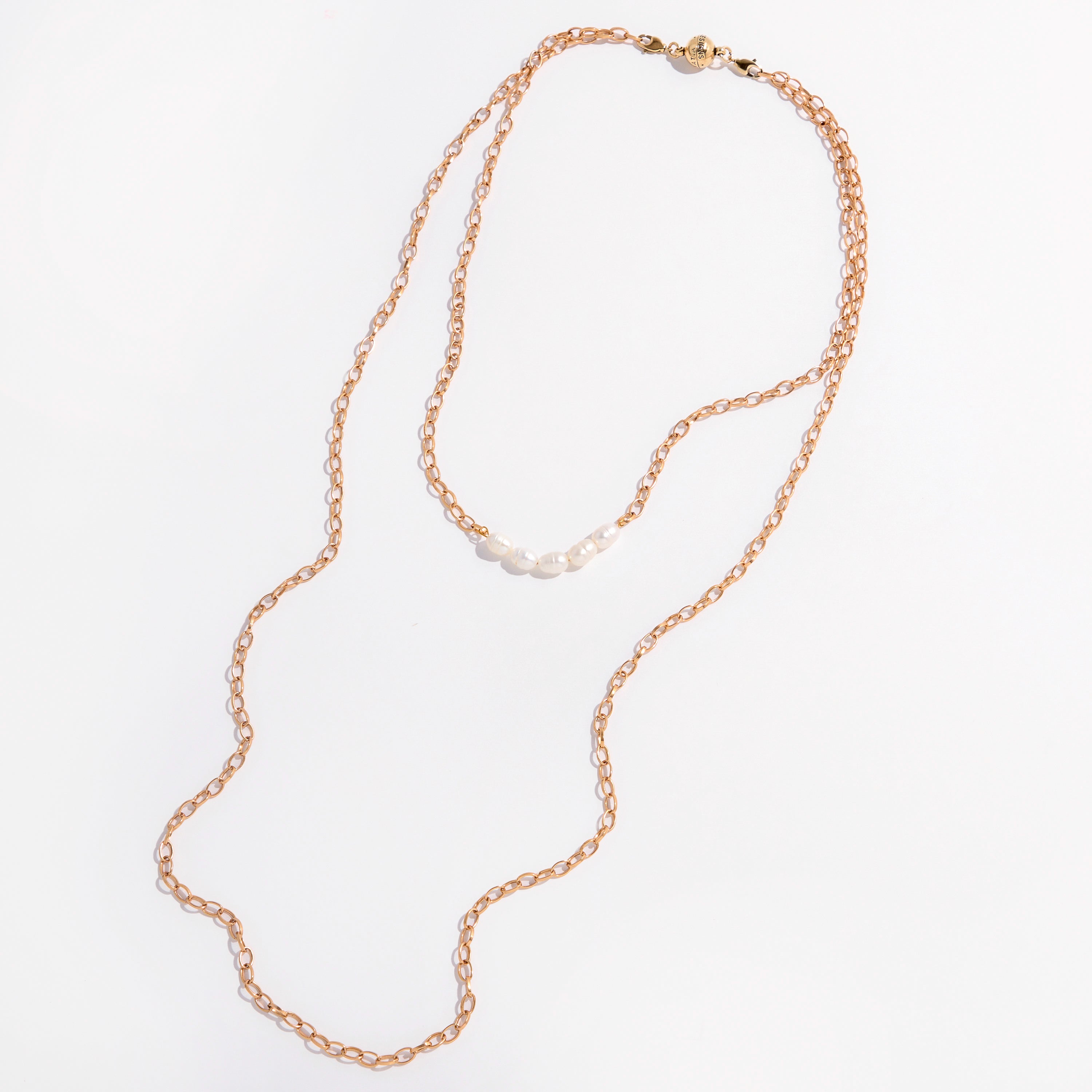 Two layering chain necklaces with pearl accent stones, one plated in gold and the other in silver, displayed against a white background.