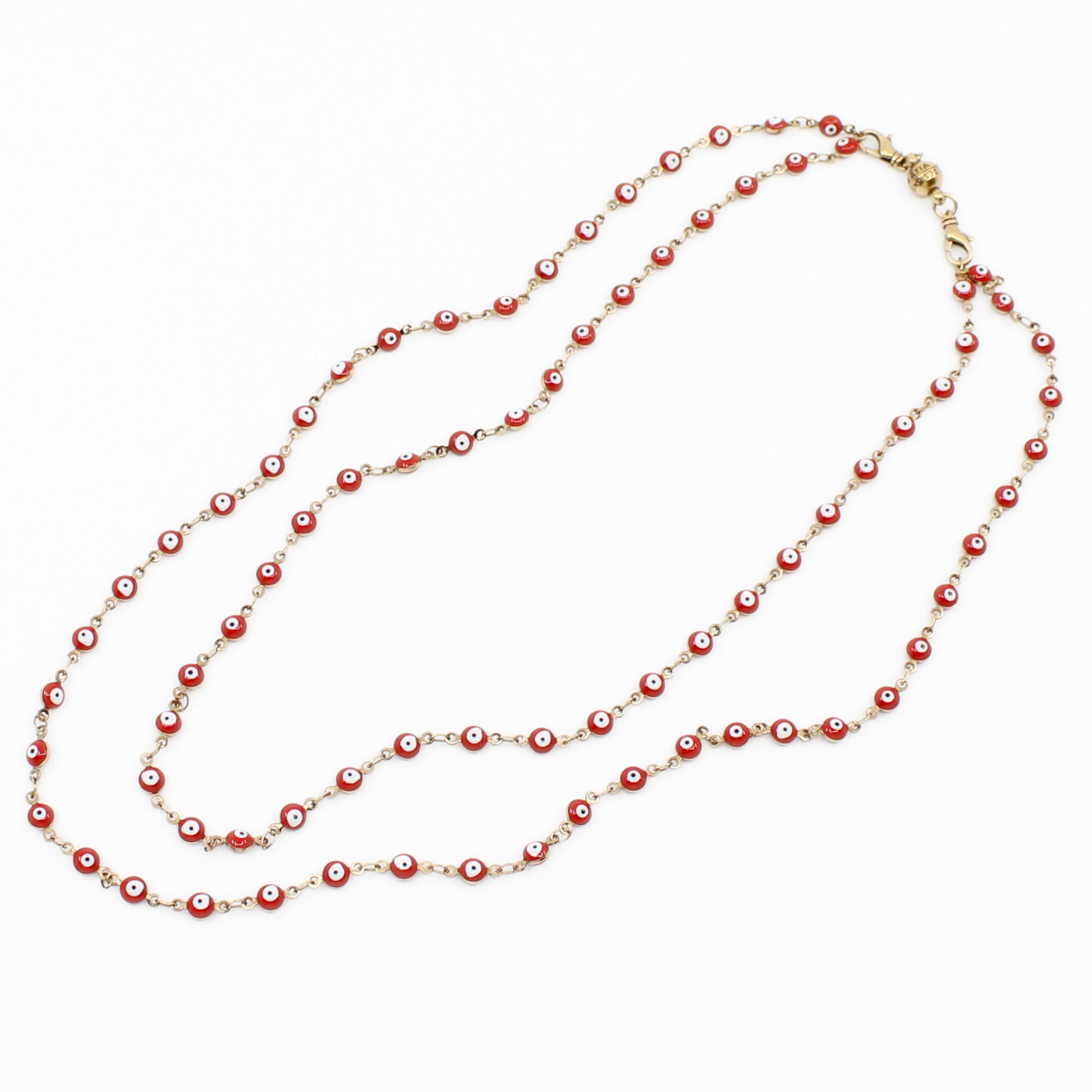 Long necklace with red and gold beads on a white background