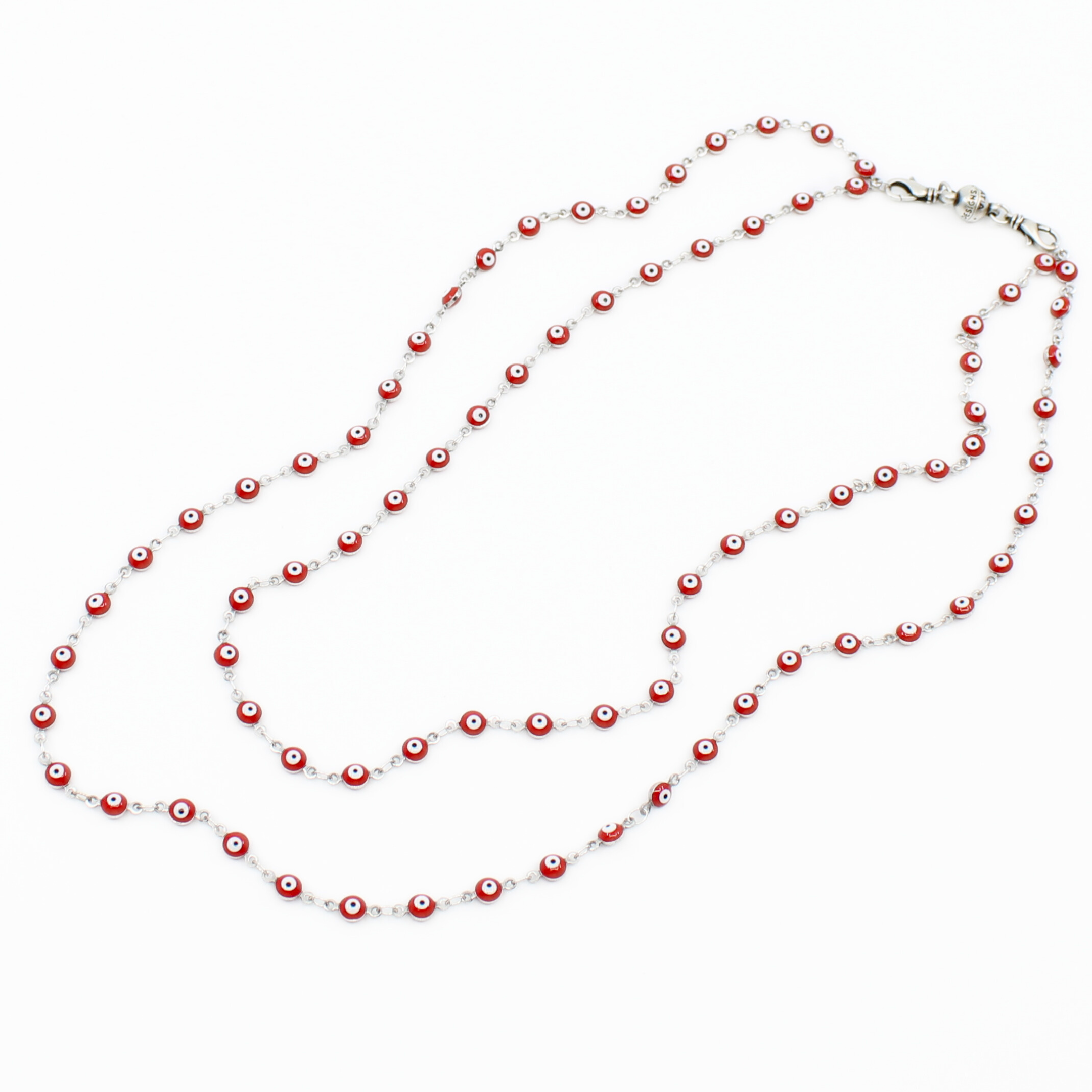 Long necklace with red and white beads on a white background