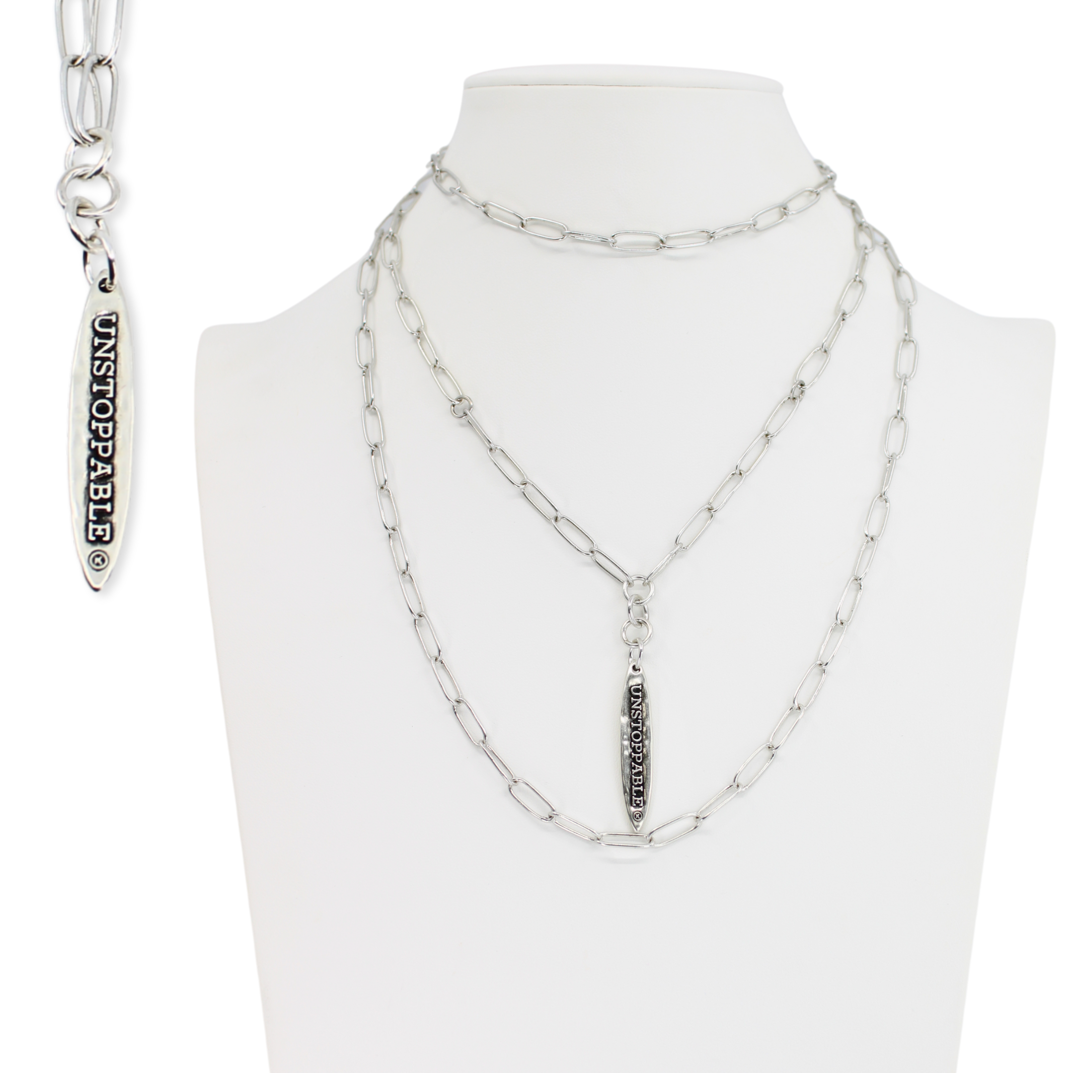 Silver chain necklace with pendant on a mannequin bust against a white background
