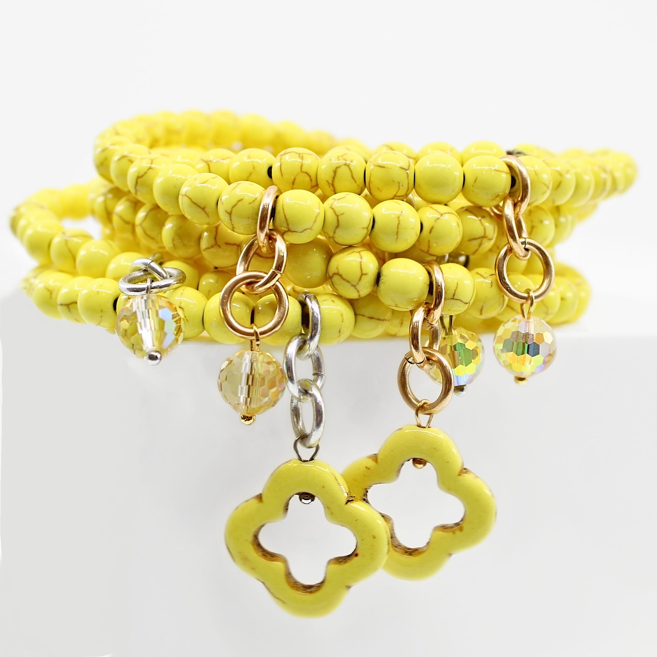 multiple colorful beaded boho wrap bracelets in 4 bright colors made with howlite beads. this image shows the yellow in 2 finish options