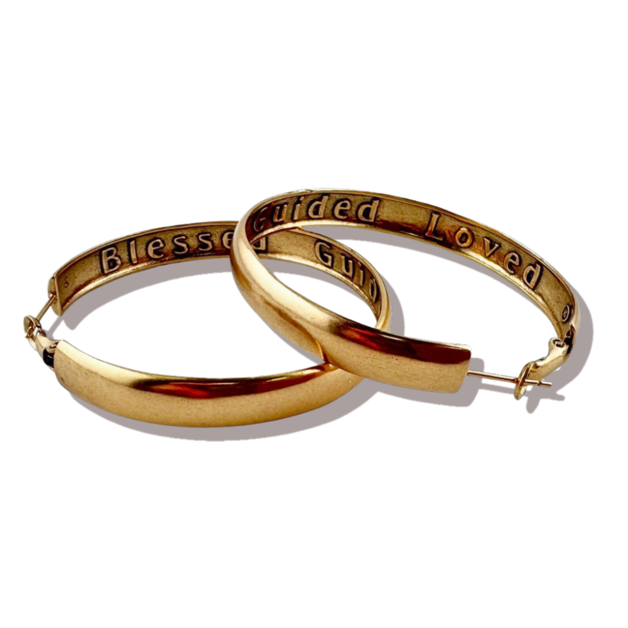 Gold hoop earrings with engraved text on a white background