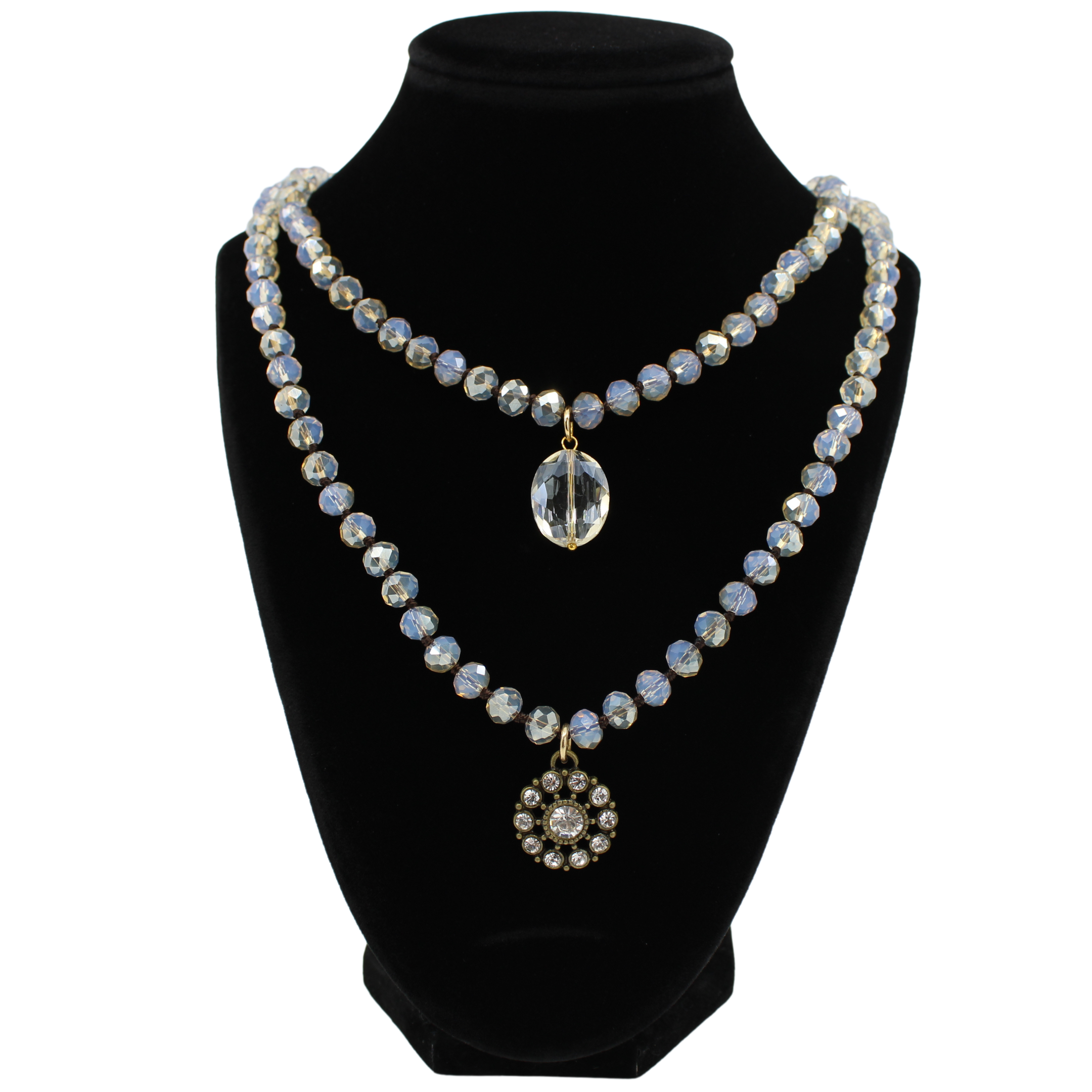 Necklace with beads and a crystal pendant on a black mannequin bust.