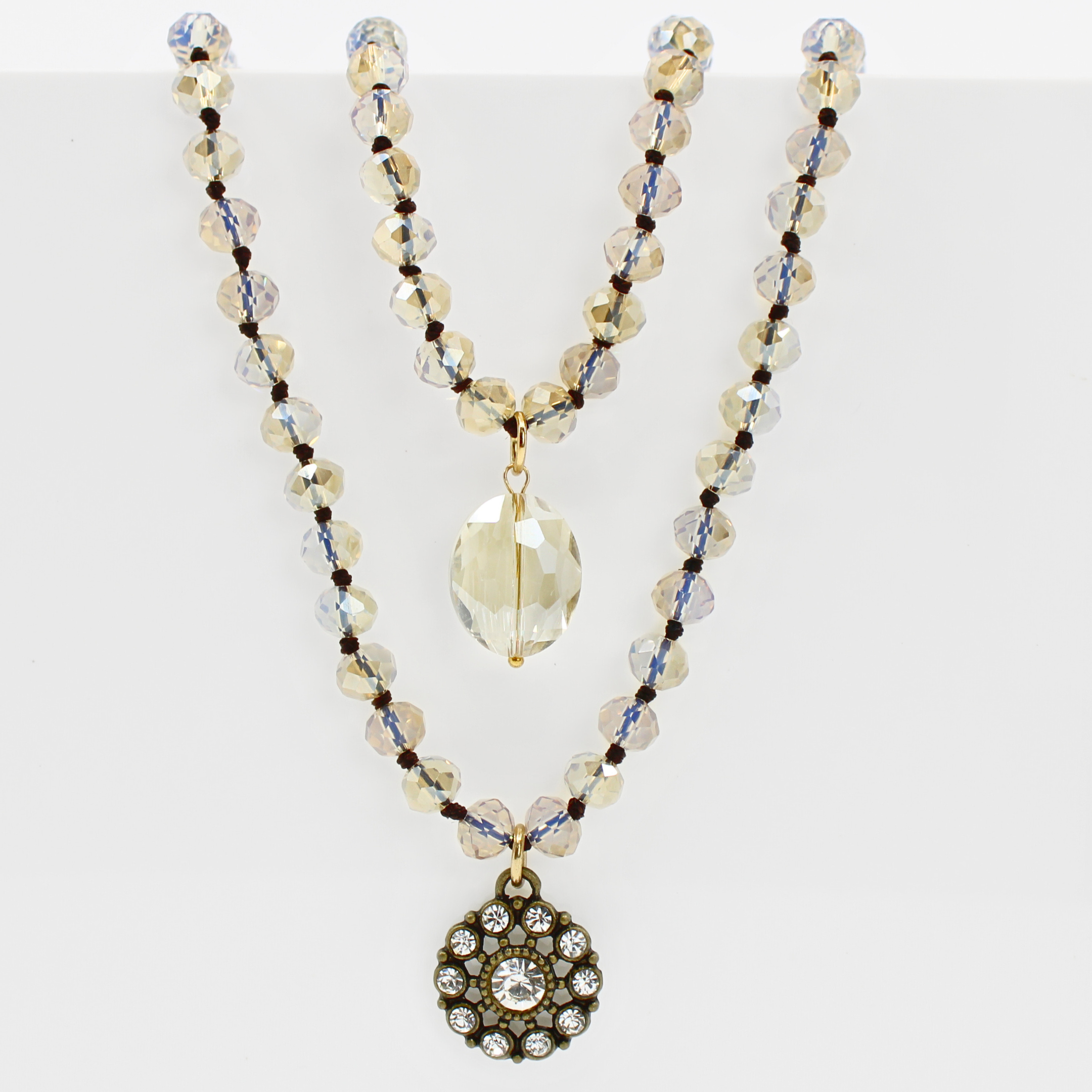 Necklace with beaded chain and decorative pendant on a white background