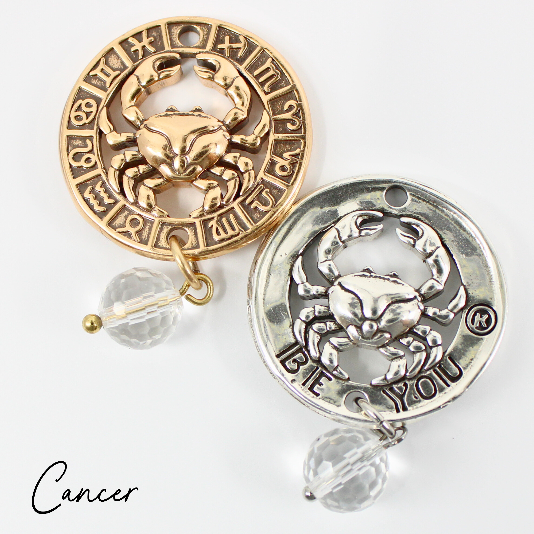 Two necklaces with gold and silver chains, featuring circular pendants with zodiac signs, and faceted crystal quartz accents.