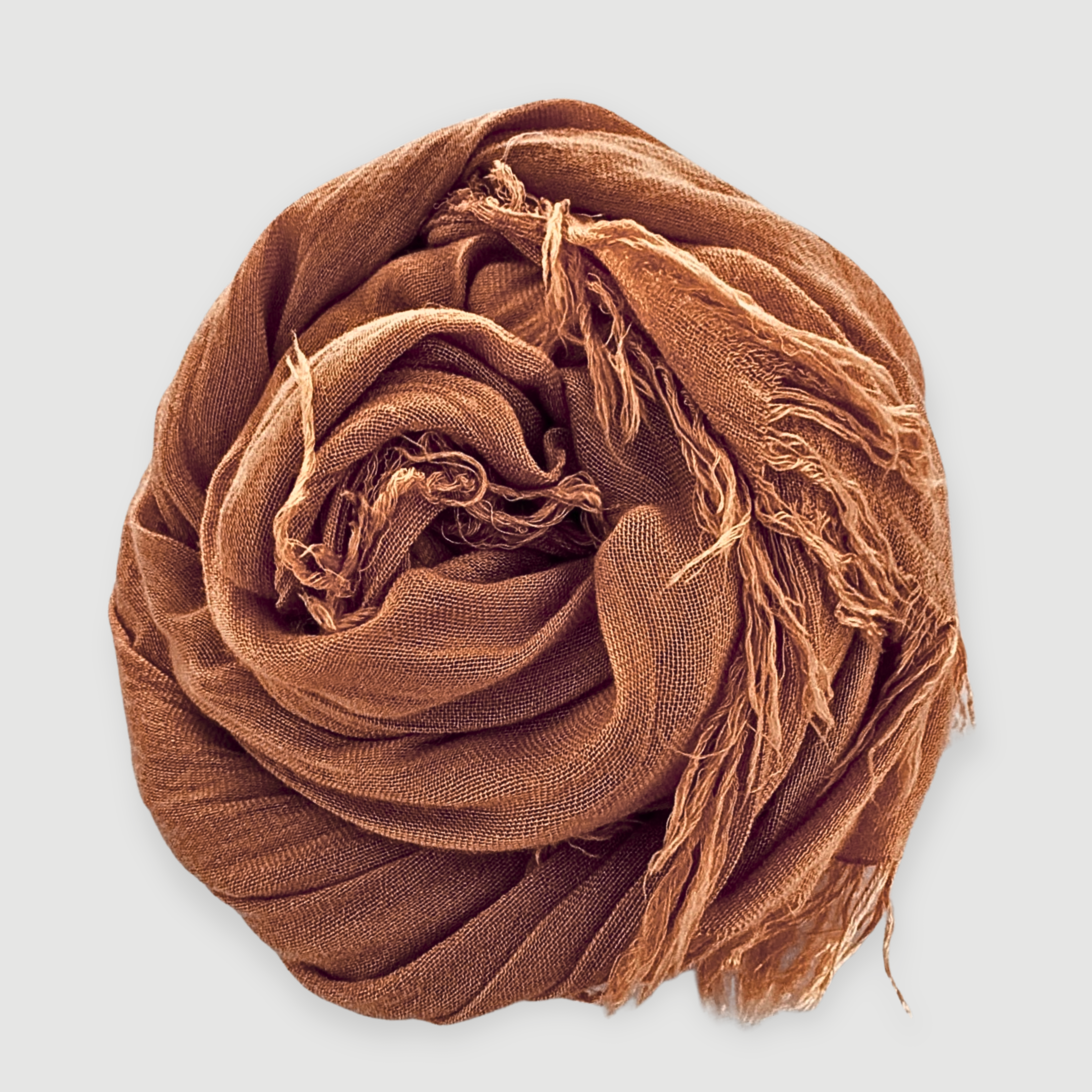 Brown scarf with fringes on a light gray background
