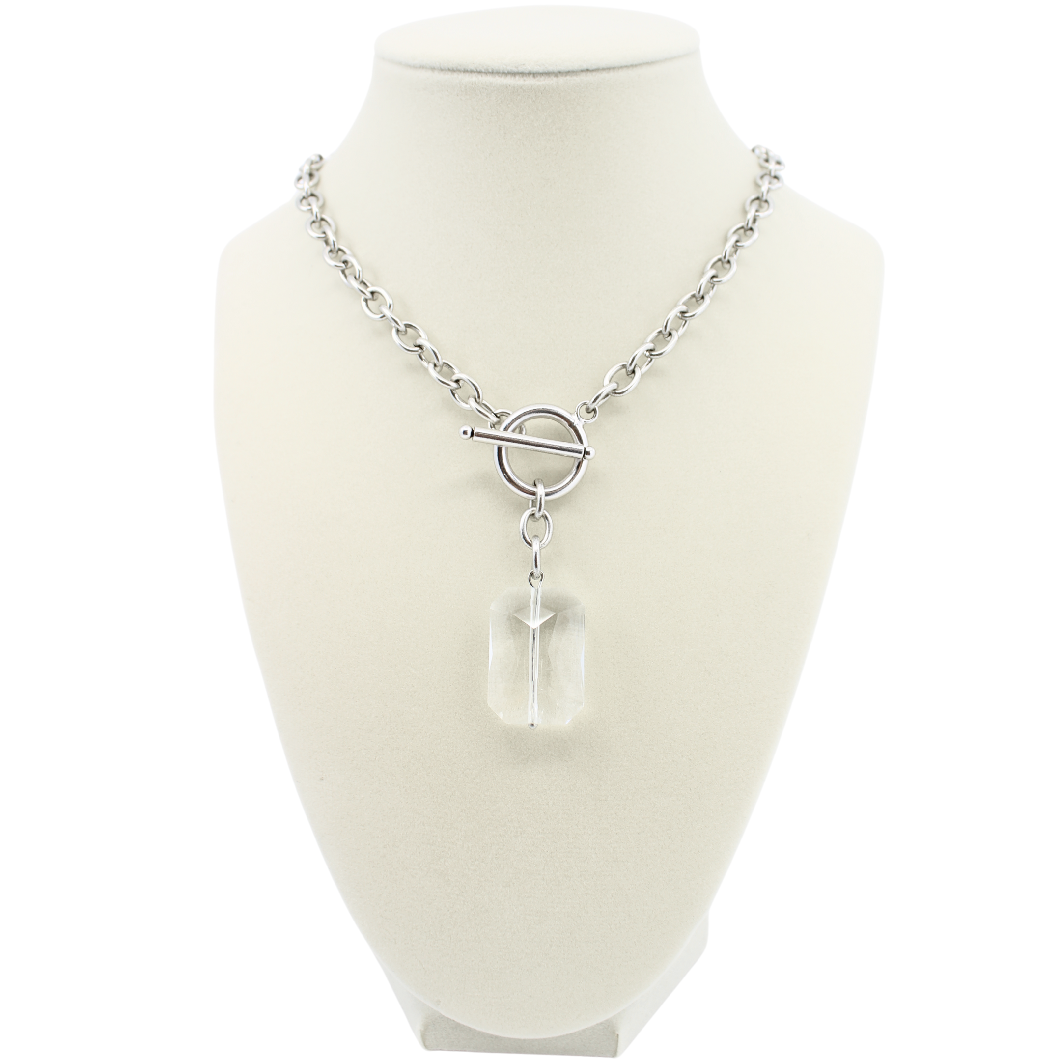 Silver necklace with a clear pendant on a mannequin bust against a white background