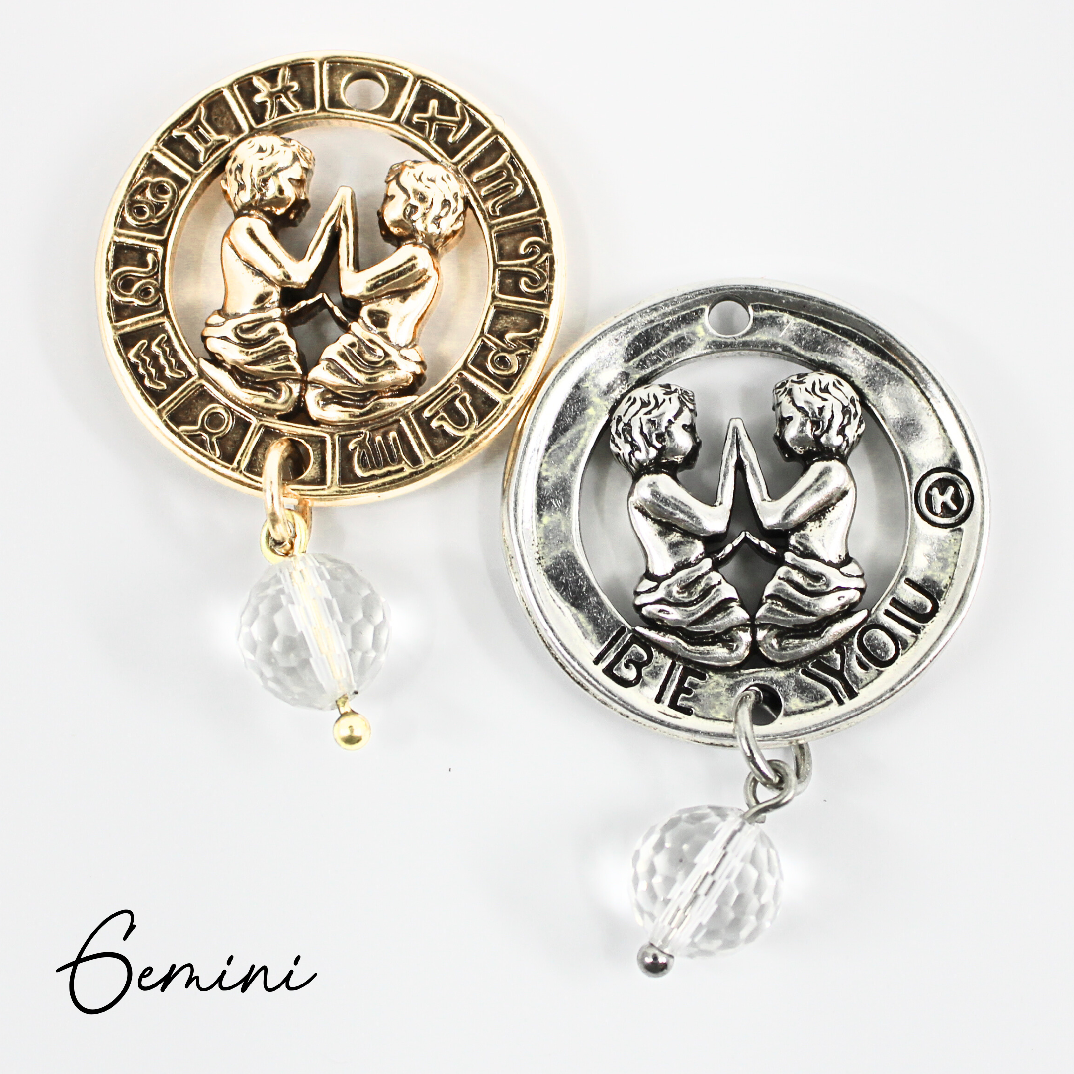 Two necklaces with gold and silver chains, featuring circular pendants with zodiac signs, and faceted crystal quartz accents.