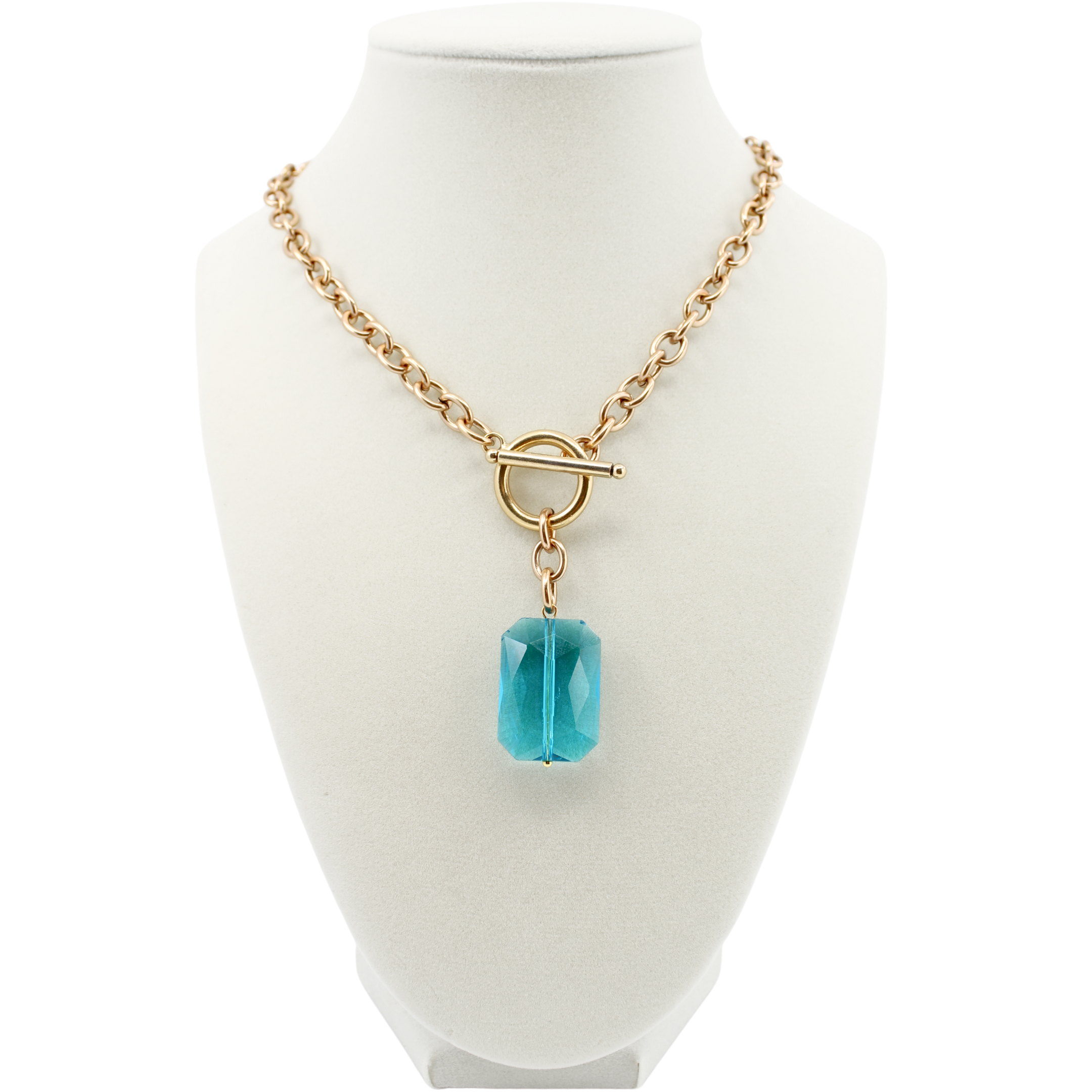 Gold necklace with a blue pendant on a white mannequin bust.