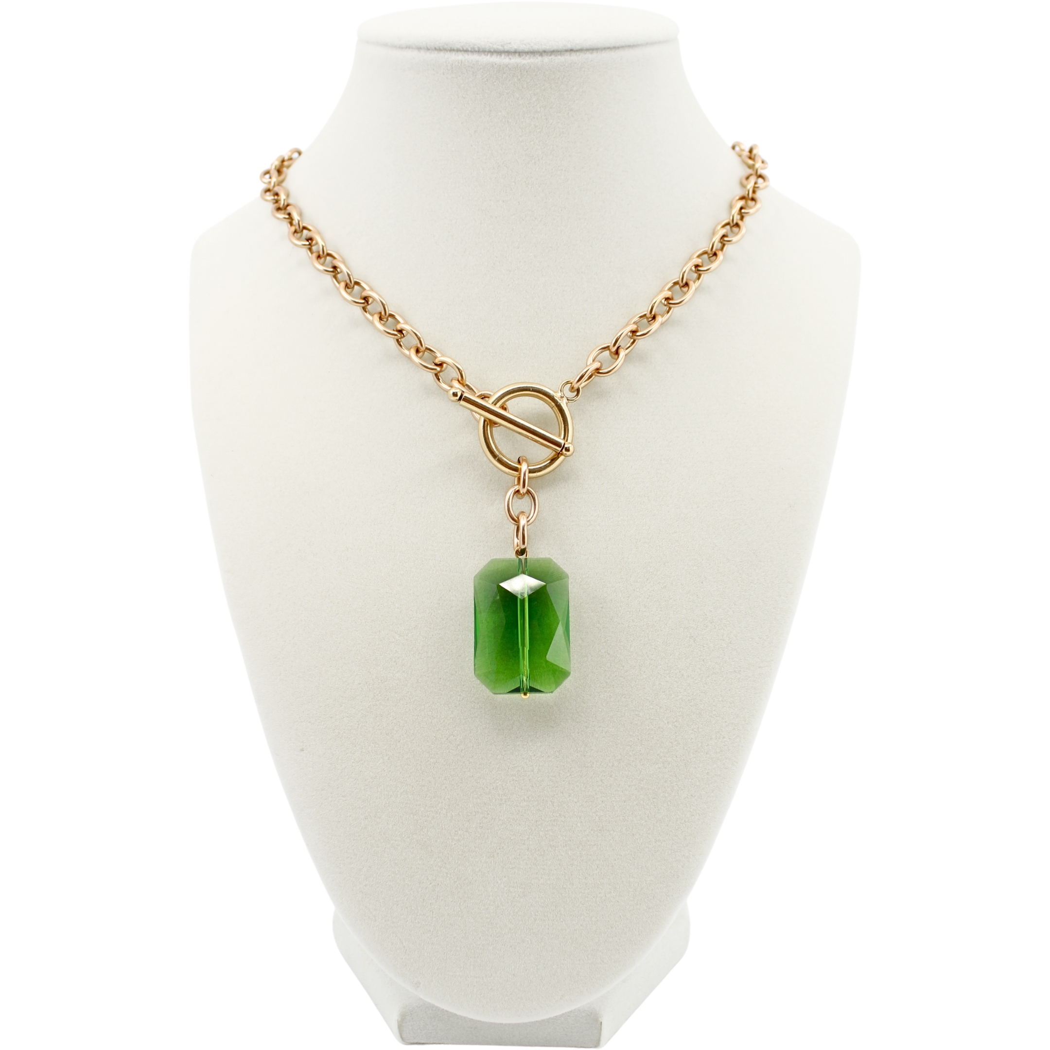 Necklace with a green pendant on a white mannequin bust