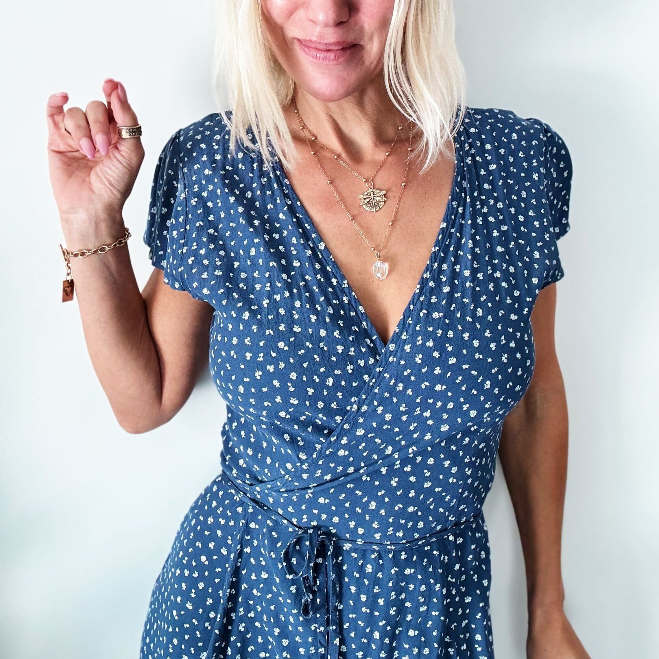 dragonfly pendant detail in gold and silver with message on back reads "all is well"