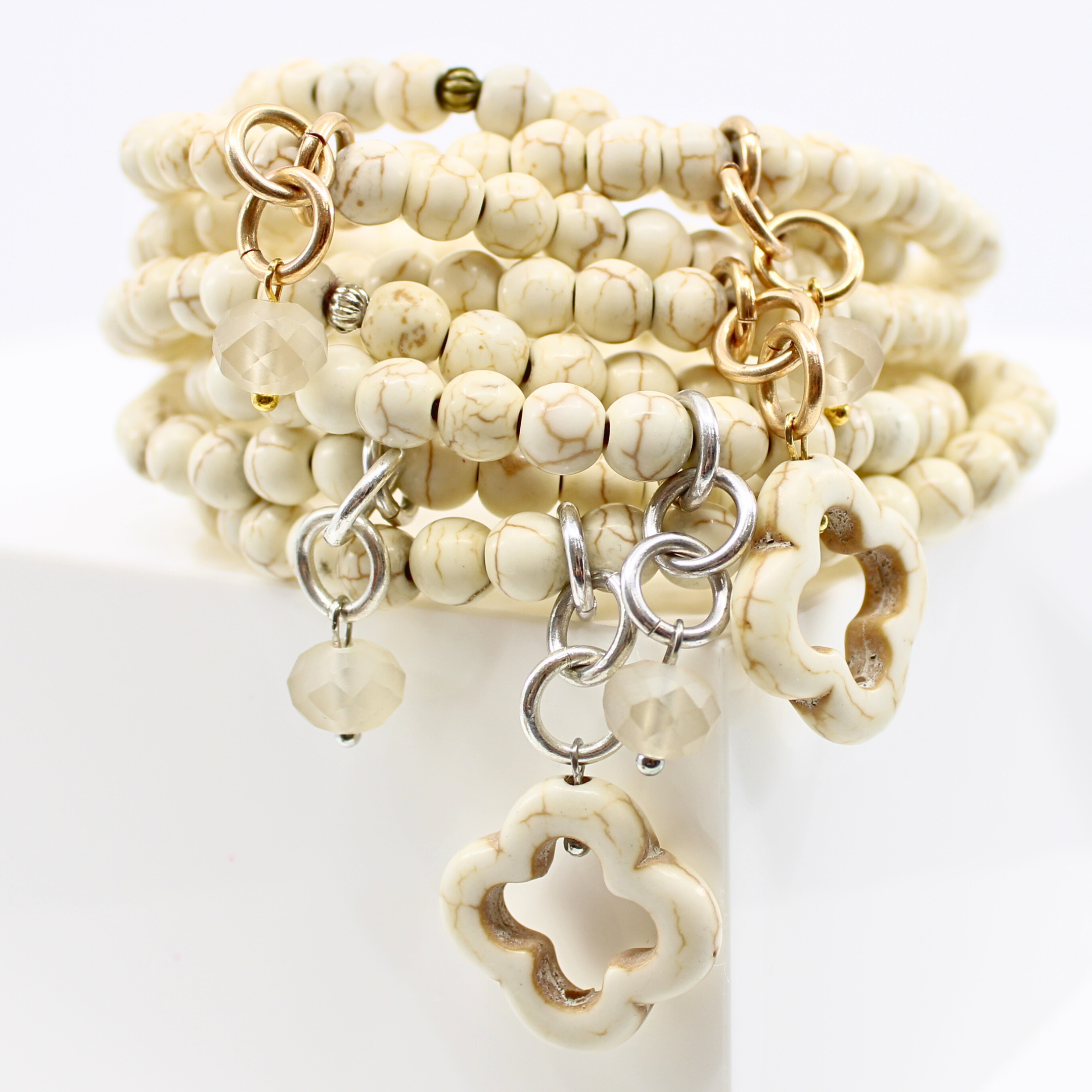 multiple colorful beaded boho wrap bracelets in 4 bright colors made with howlite beads. this image shows the off-white in both finish options