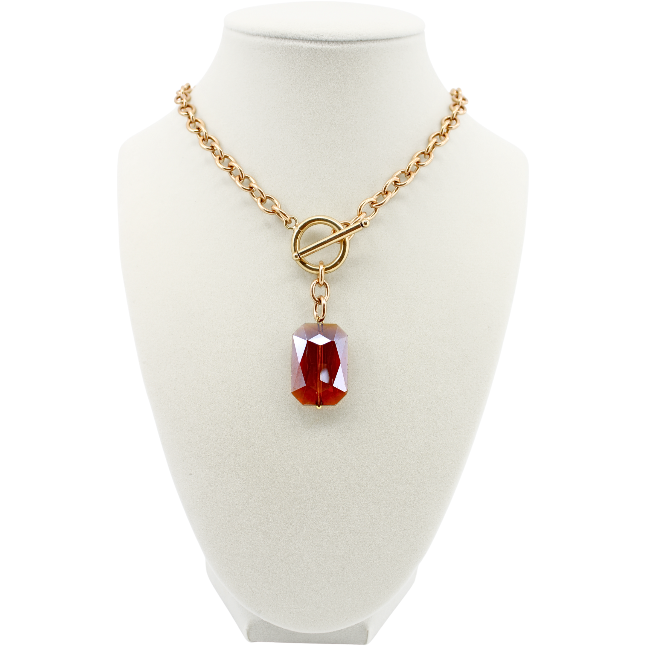 Gold necklace with a red pendant on a white mannequin bust.