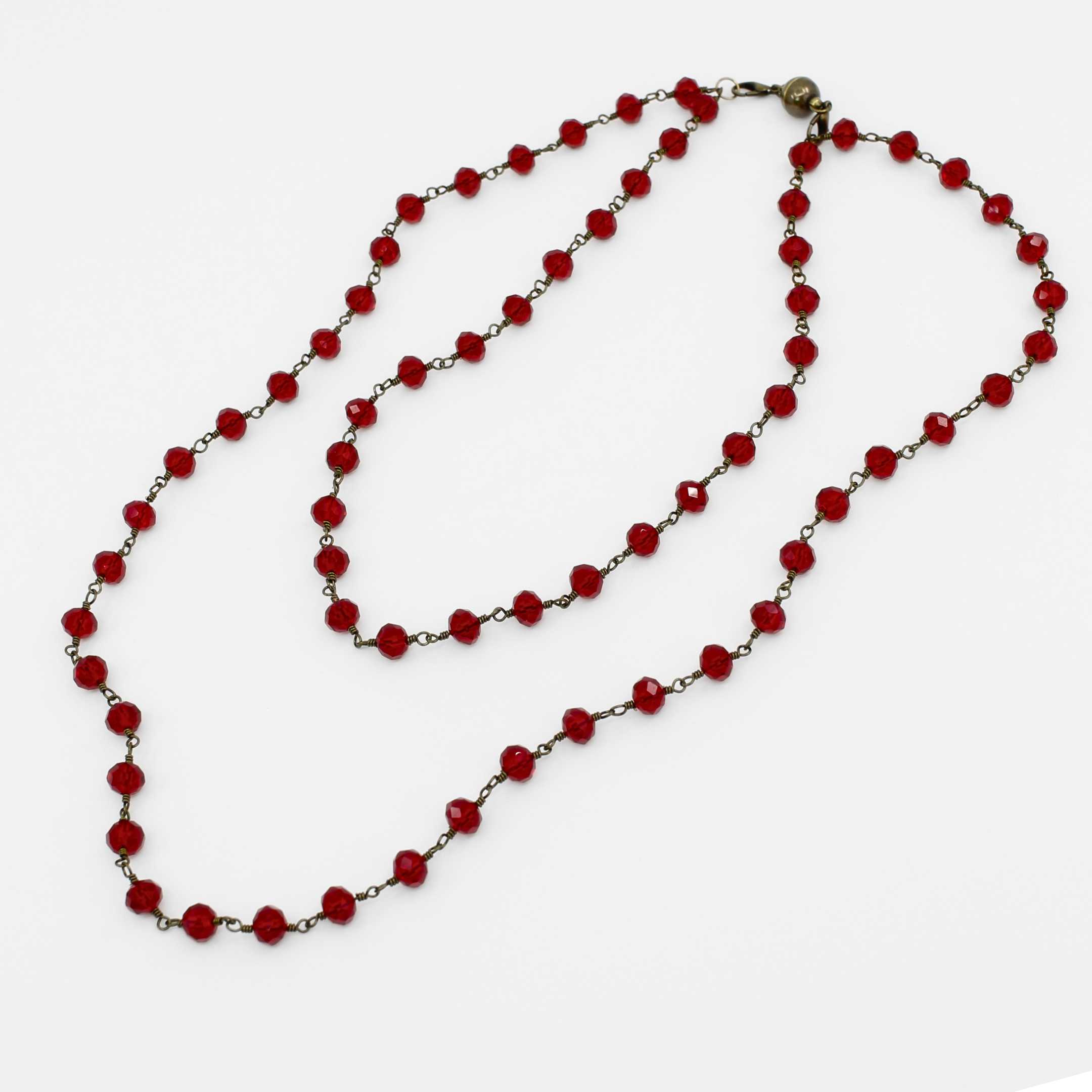 Red beaded necklace on a white background
