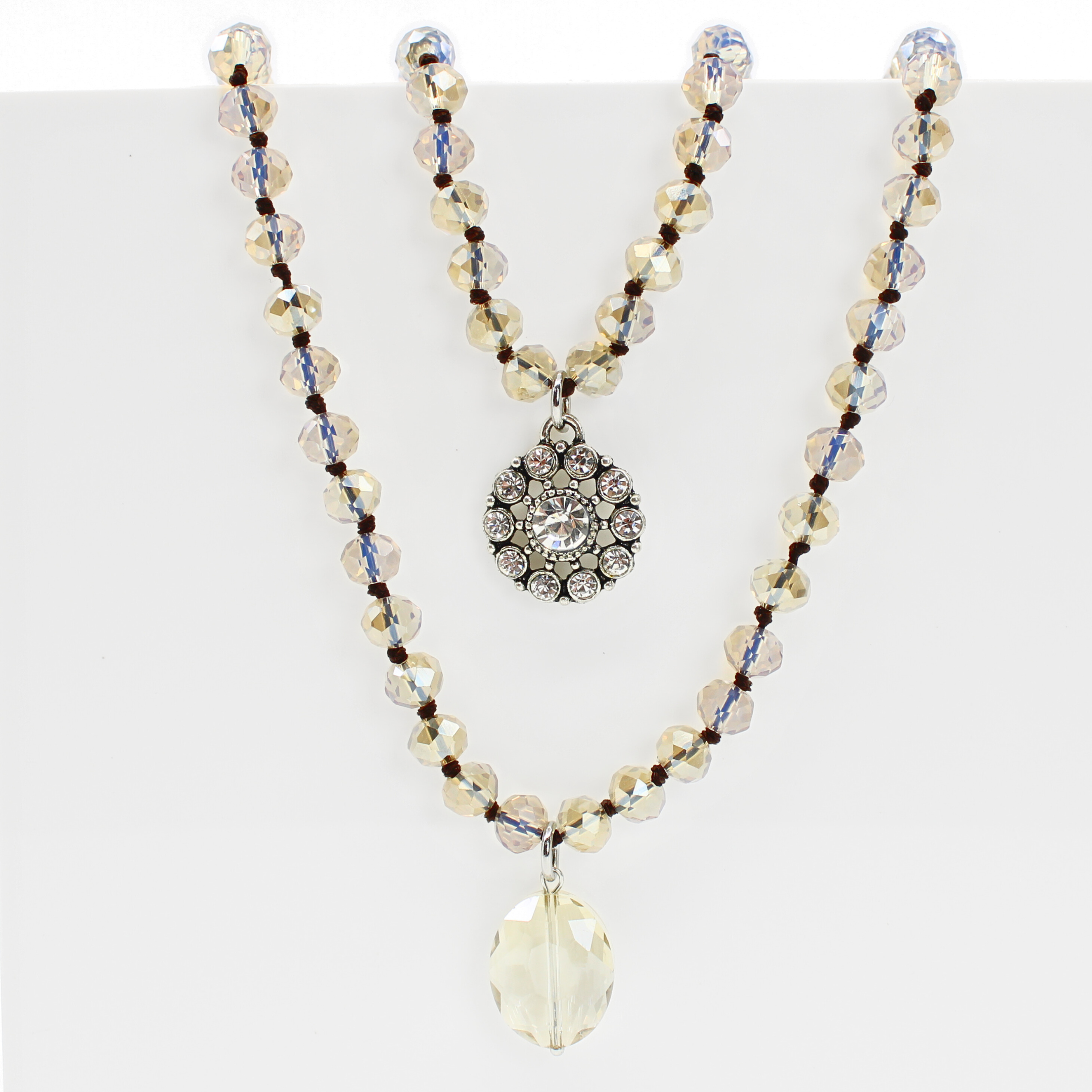Necklace with beads and a decorative pendant on a white background