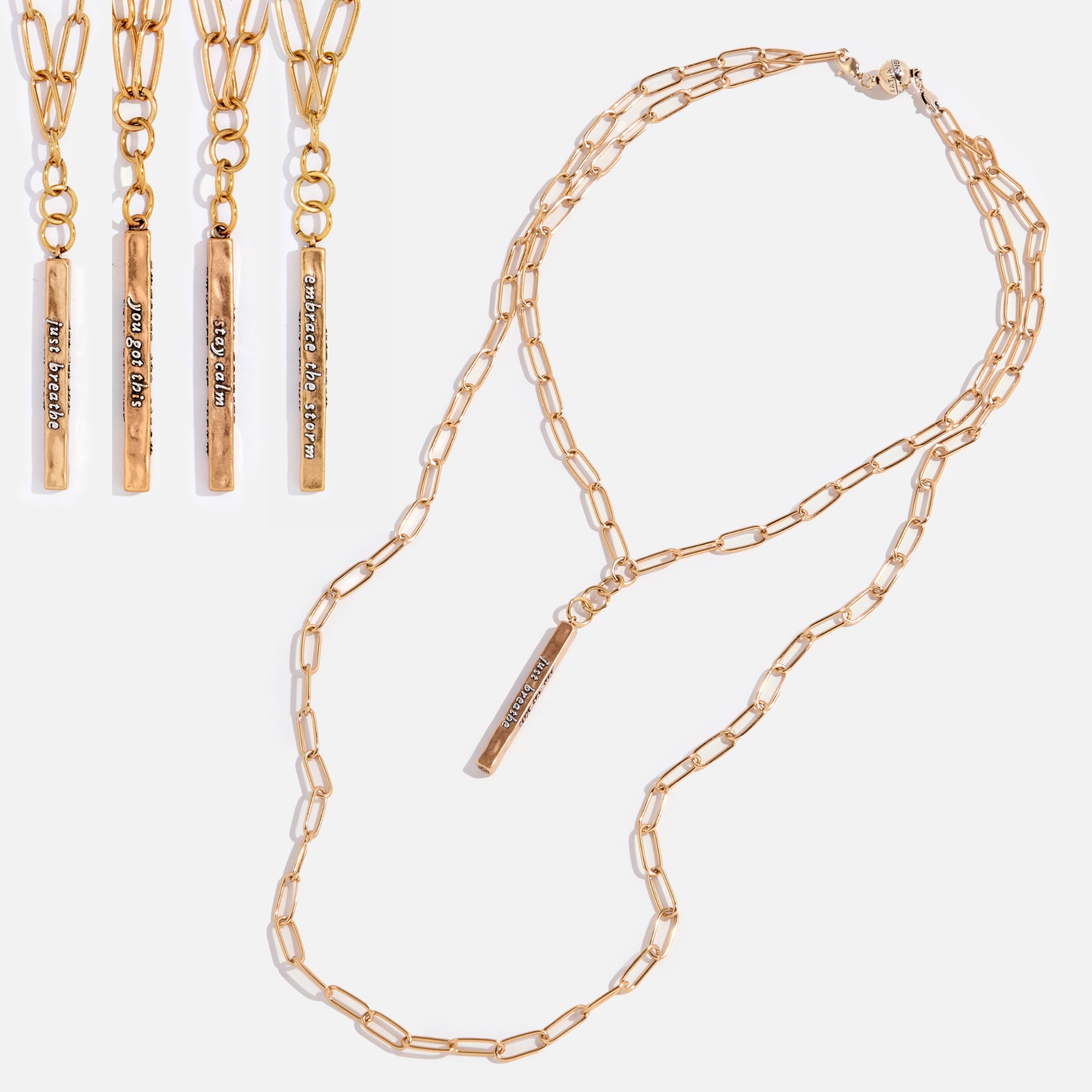 Gold chain necklace with personalized engraved tag on a white background.