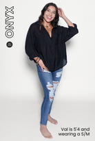 Woman wearing a black shirt and blue jeans on a white background 