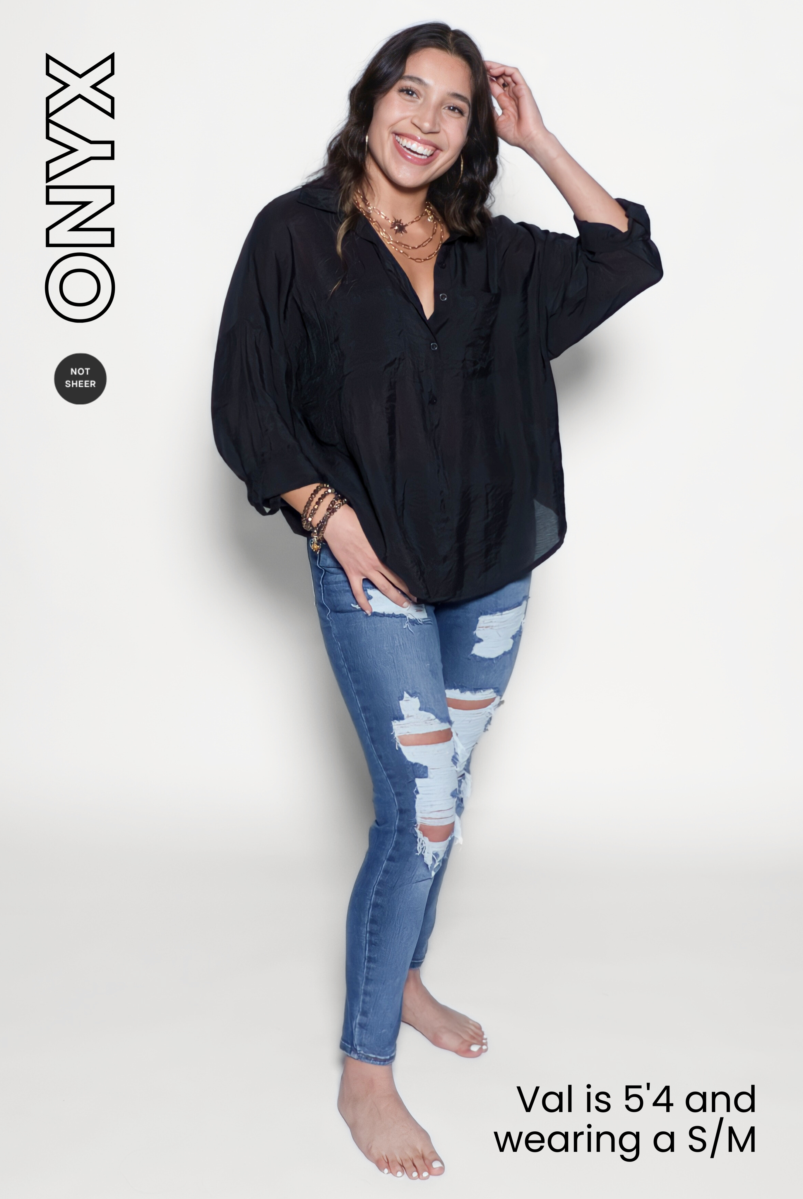 Woman wearing a black shirt and blue jeans on a white background 