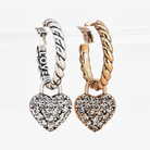 Two heart-shaped hoop earrings, one silver and one gold, on a white background.