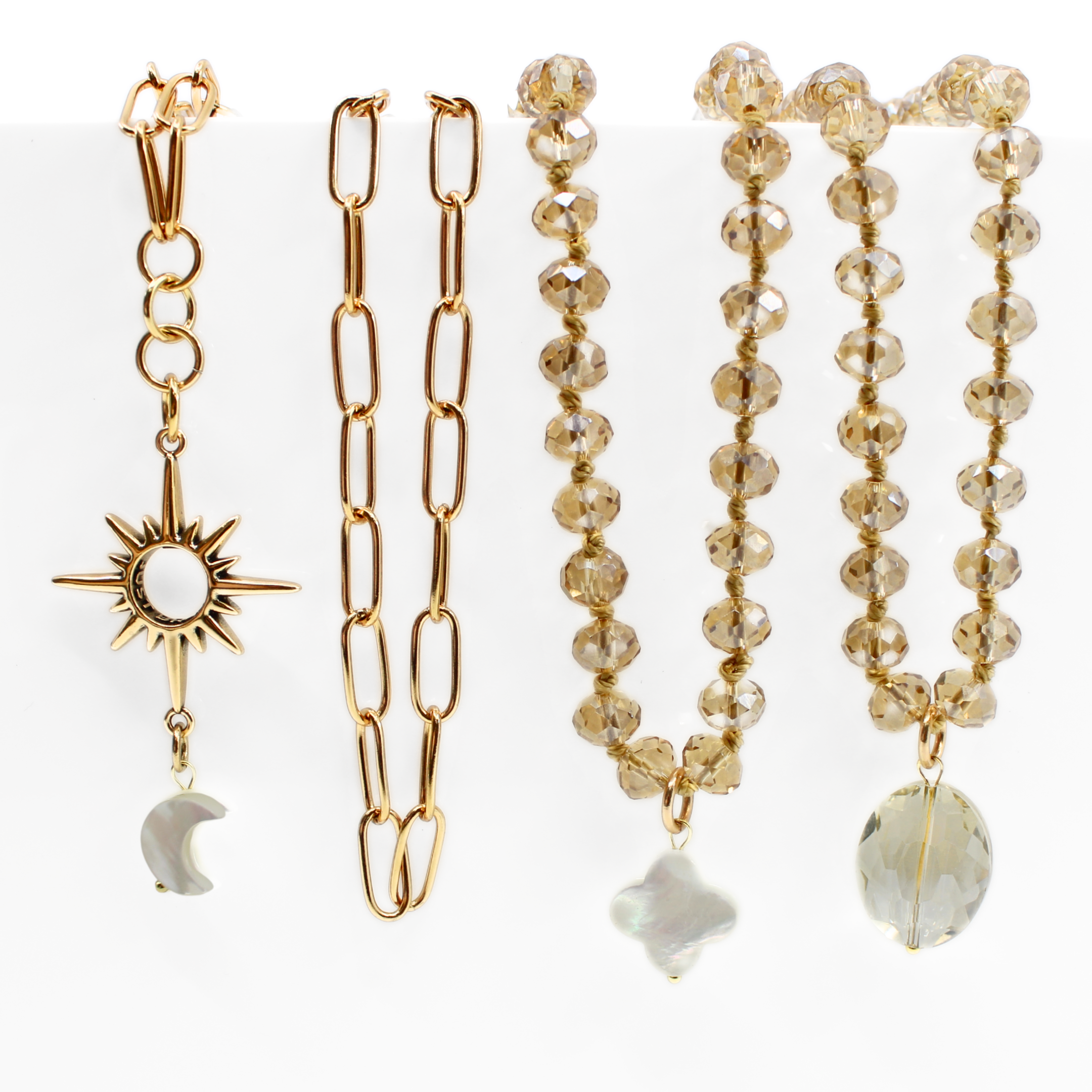 Set of gold and beaded jewelry on a white background