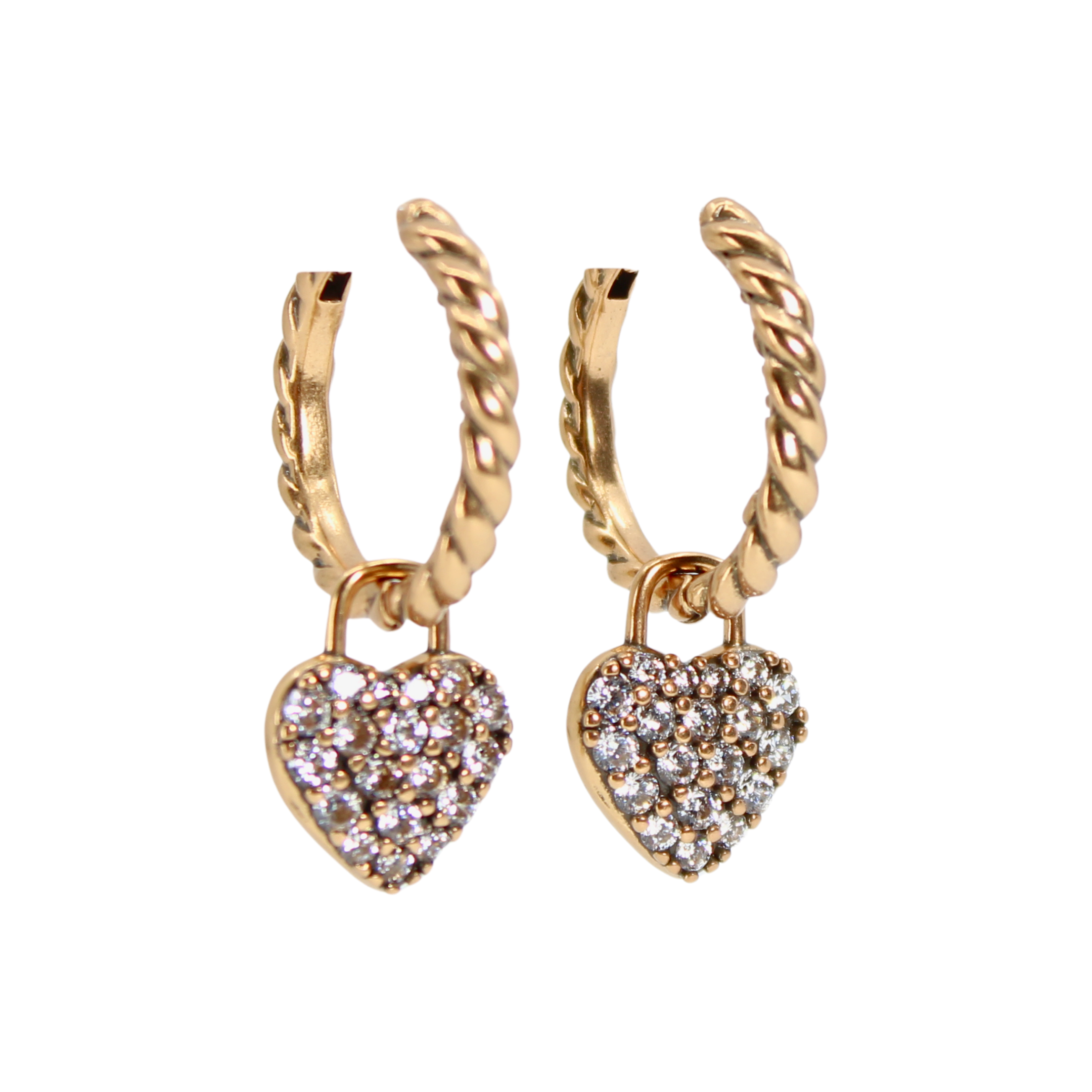 Gold hoop earrings with heart-shaped charms on a white background