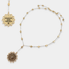 Gold necklace with decorative pendants on a white background