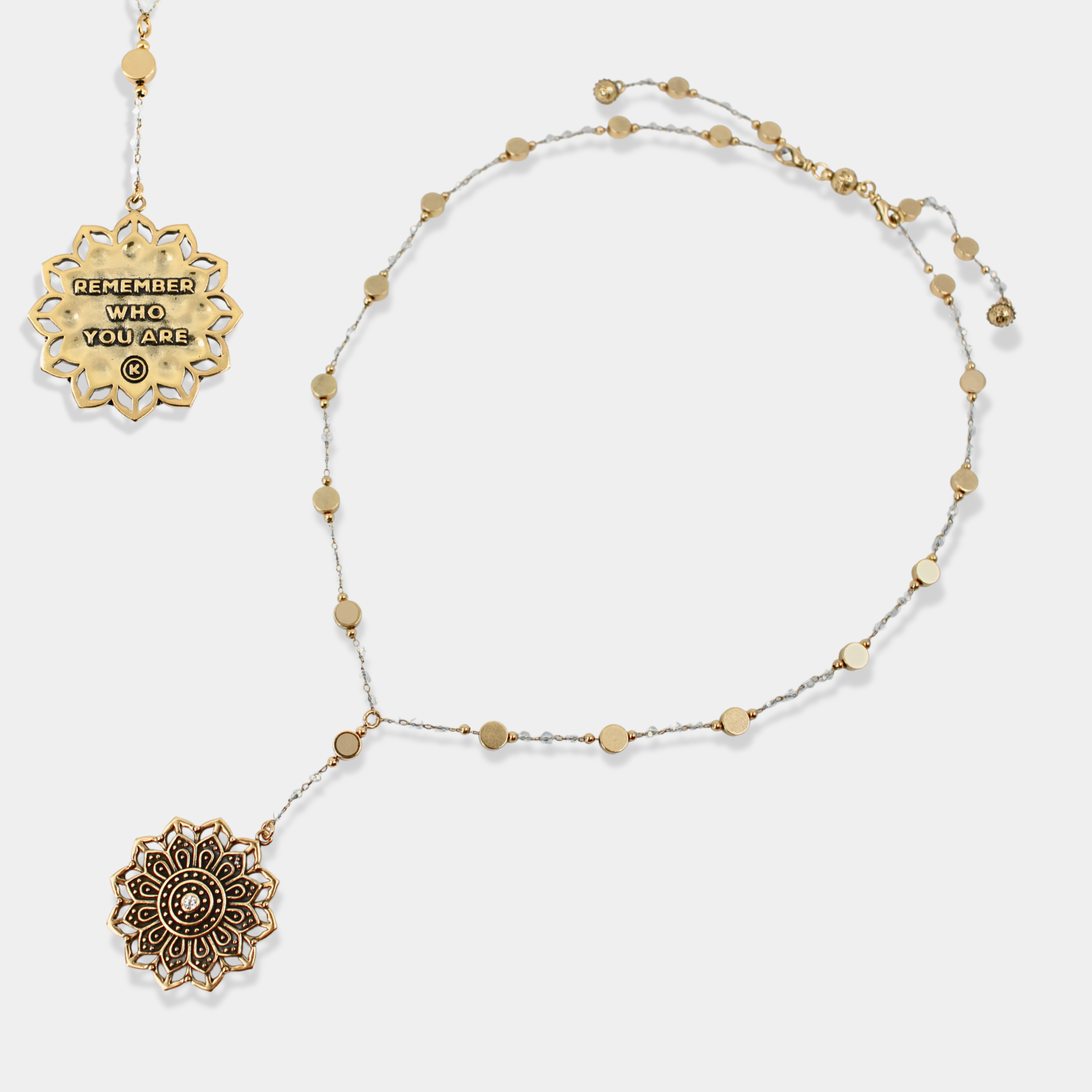 Gold necklace with decorative pendants on a white background
