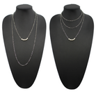 Two layering chain necklaces, one in gold finish and one in silver, each with pearl accent stones.