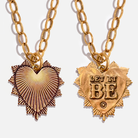 Two gold necklaces with heart-shaped pendants on a white background