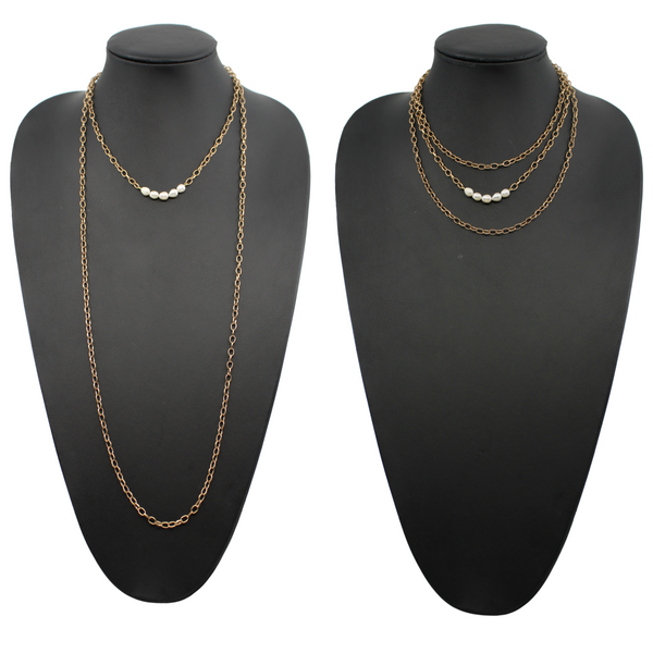 Two layering chain necklaces, one in gold finish and one in silver, each with pearl accent stones.
