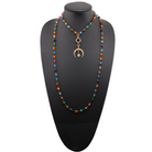 A long rosary chain necklace with black and multicolored beads, featuring crescent moon charms and a magnetic clasp.