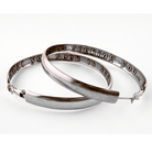 Silver hoop earrings with engraved text on a white background