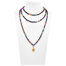 Colorful beaded necklace with a yellow pendant on a white mannequin.